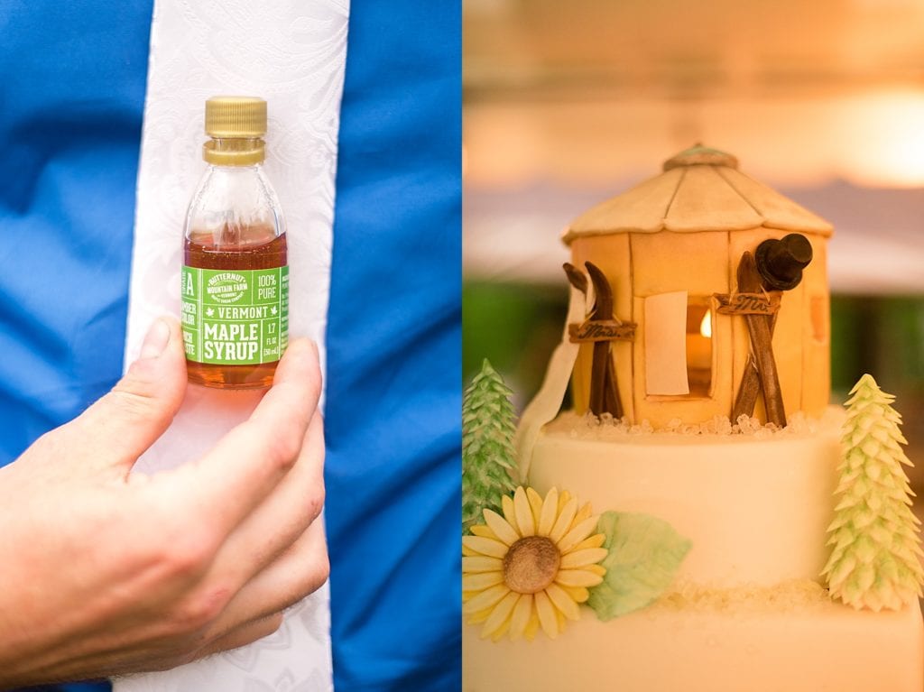 groom holding small bottle of maple syrup, and yurt cake topper