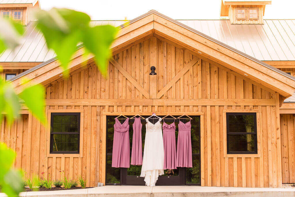 bridemaids dresses hung on The Barn on Bull Meadow