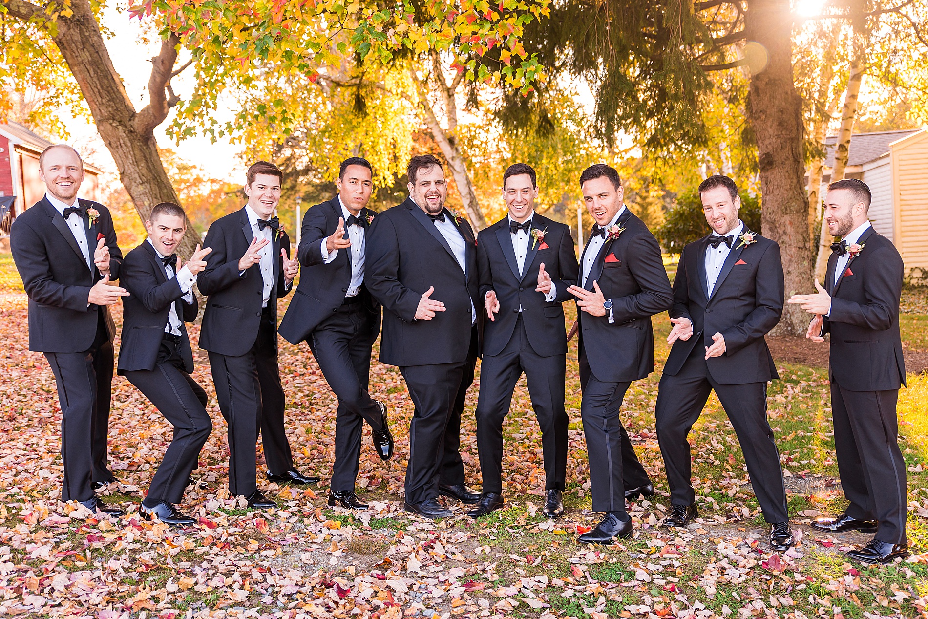 groom and groomsmen have fun posing for pictures MA fall wedding