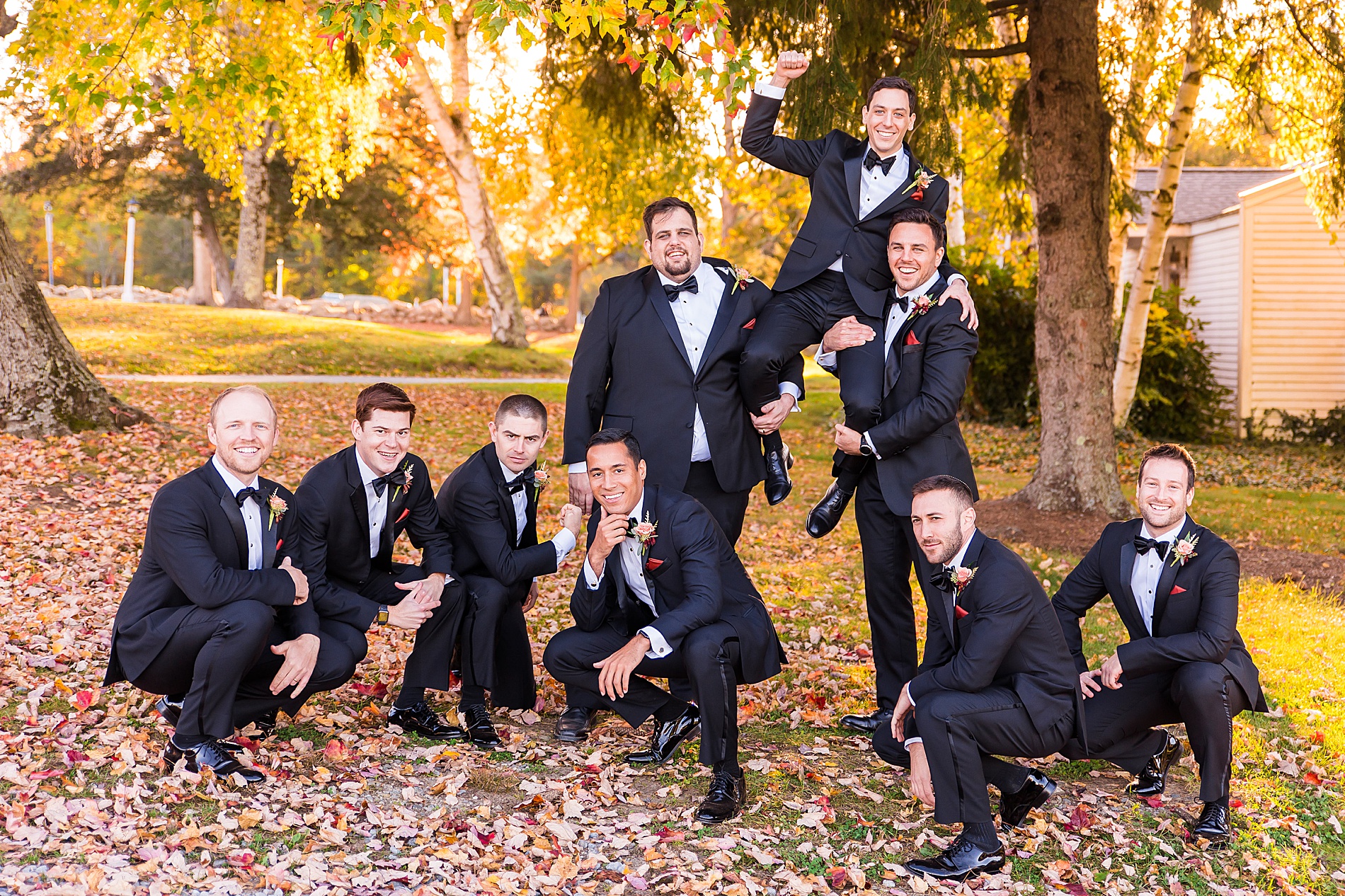 groom and groomsmen have fun posing for pictures