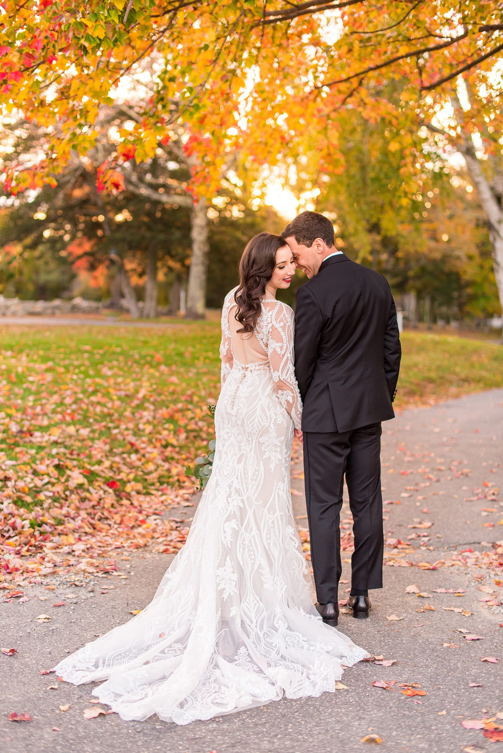 bride + groom walk down paved path at Warren Conference Center and Inn
