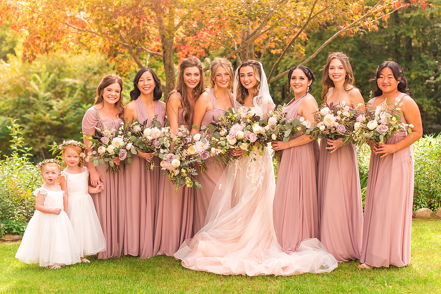 bride and Bridesmaids in Mauve dresses outside Mile Away Wedding venue in NH