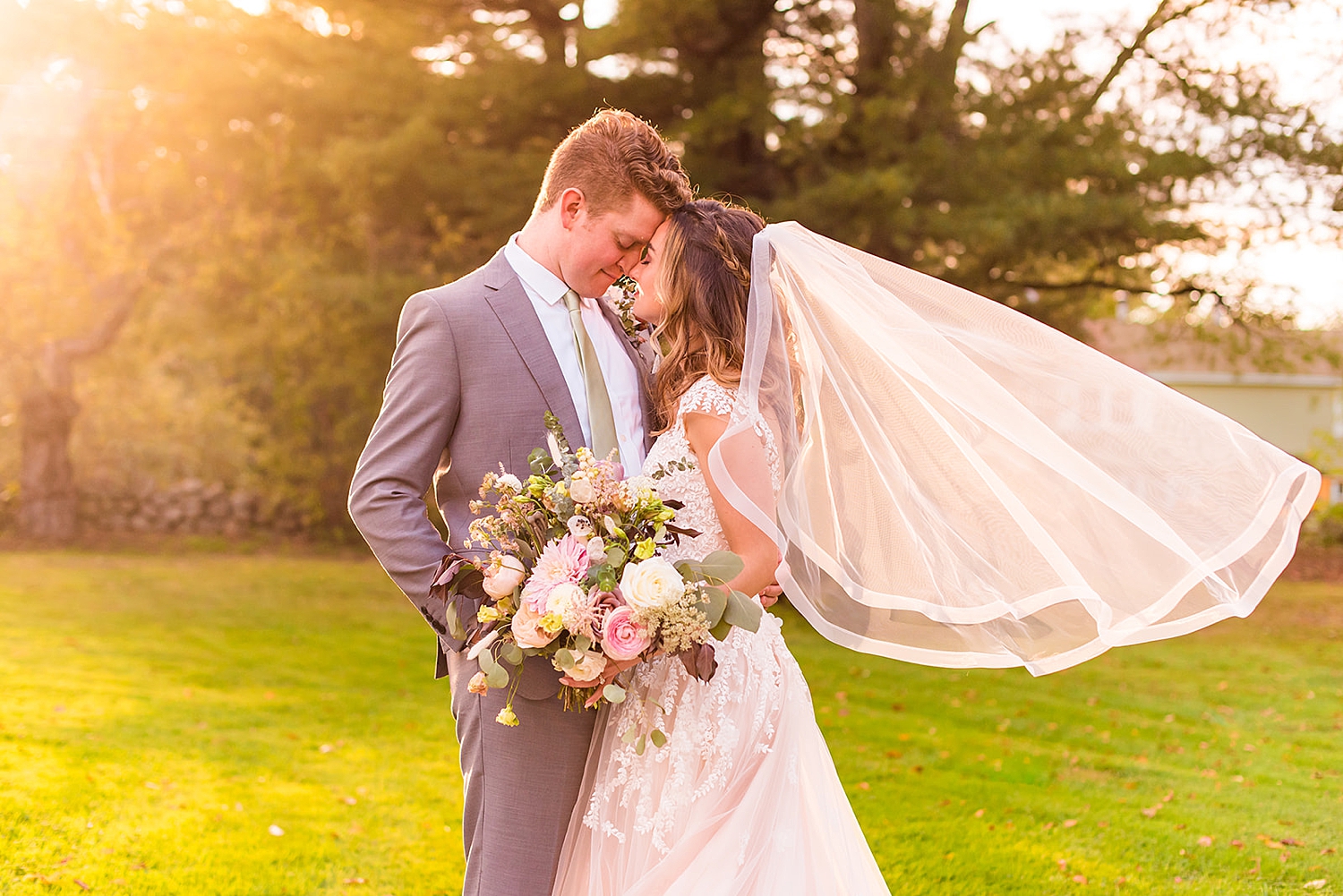 NH wedding photographer captures newlyweds kissing in the golden light