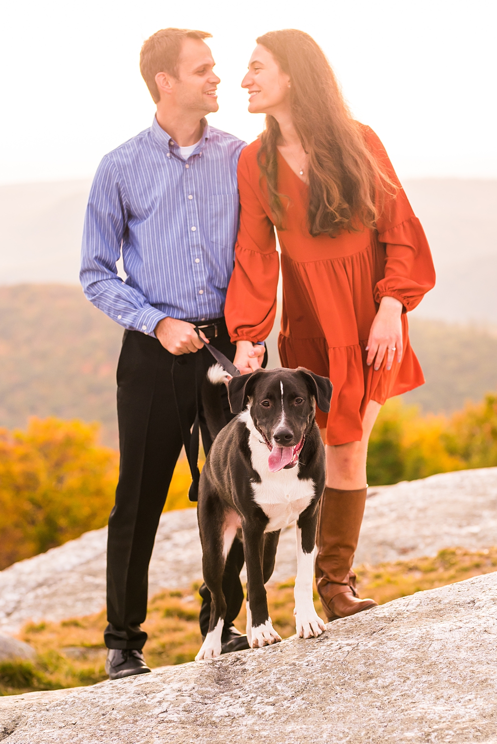 couple on mountain for engagement photo with their dog