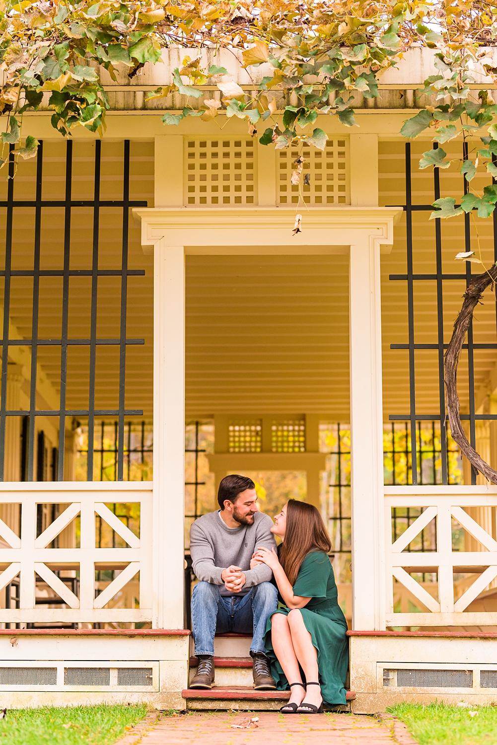 couple sitting on steps of porch during NH engagement session