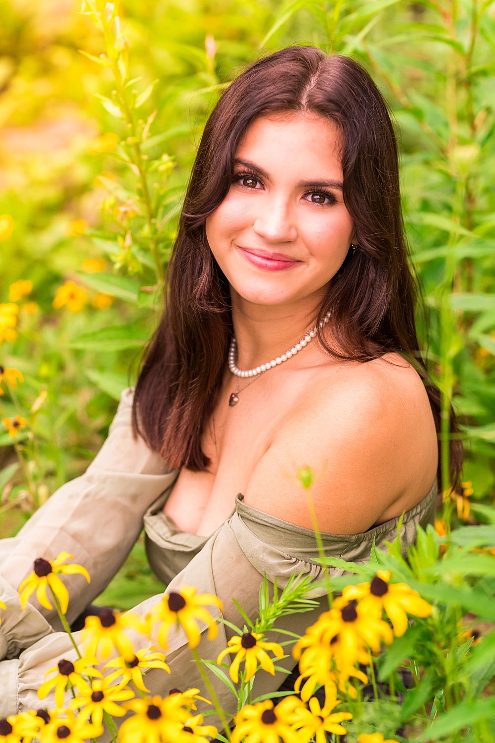 senior girl in field of yellow flowers