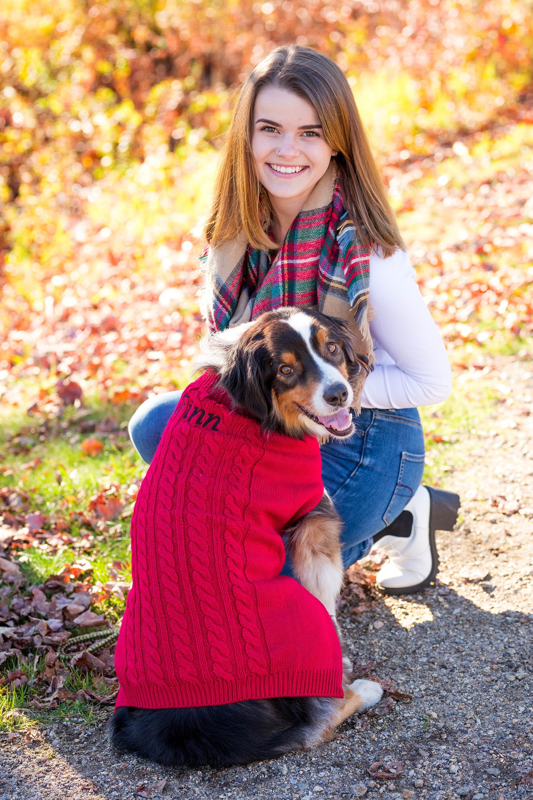 woman and dog in red sweater