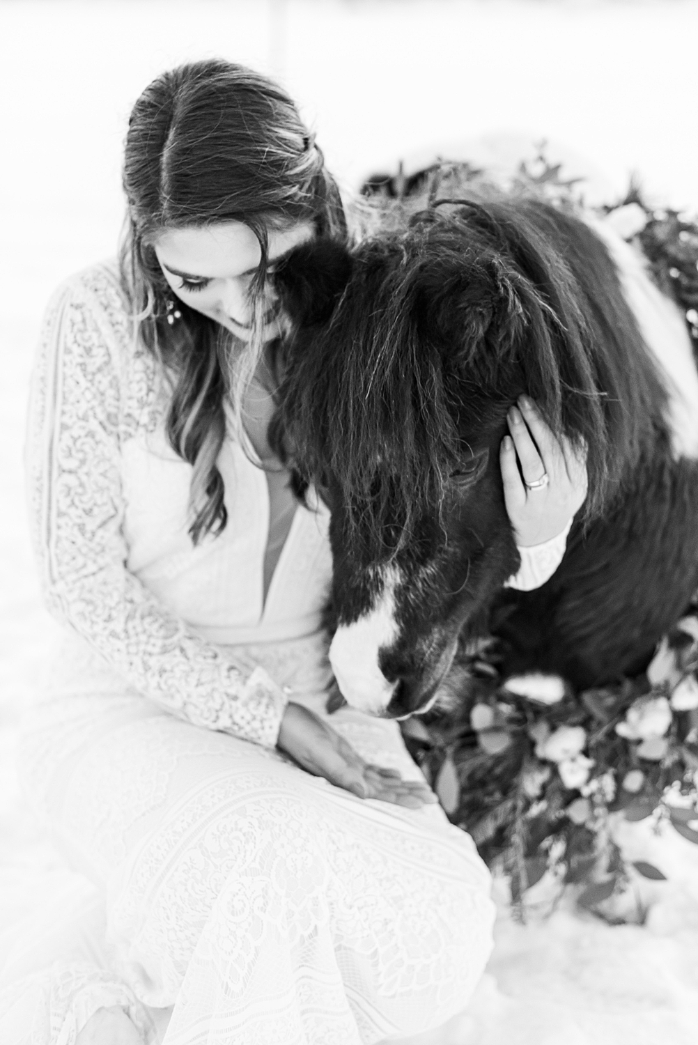 black and white photo of bride with mini horse