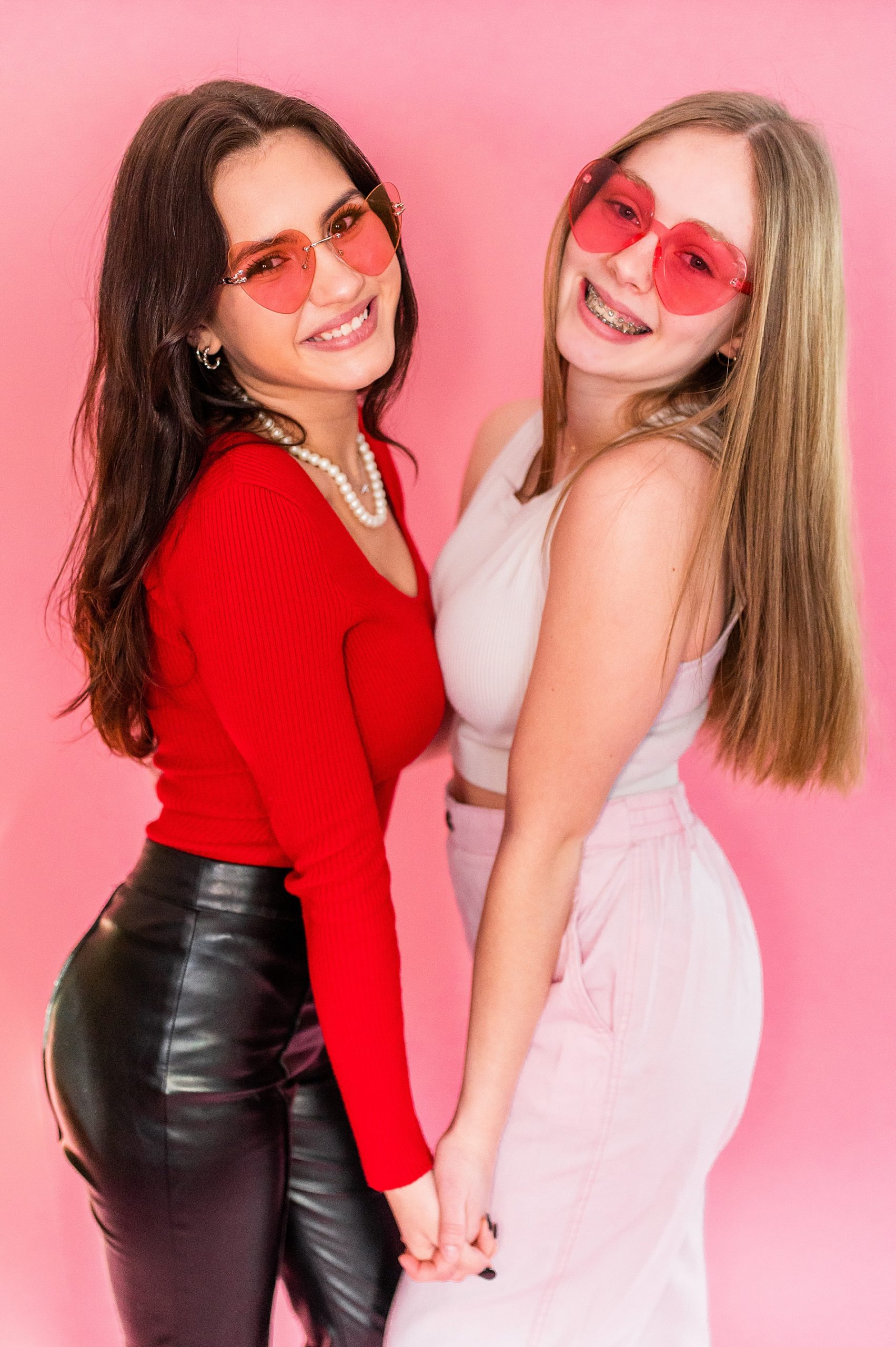 friends on the ACP senior Spokesmodel team pose together in red heart shaped glasses