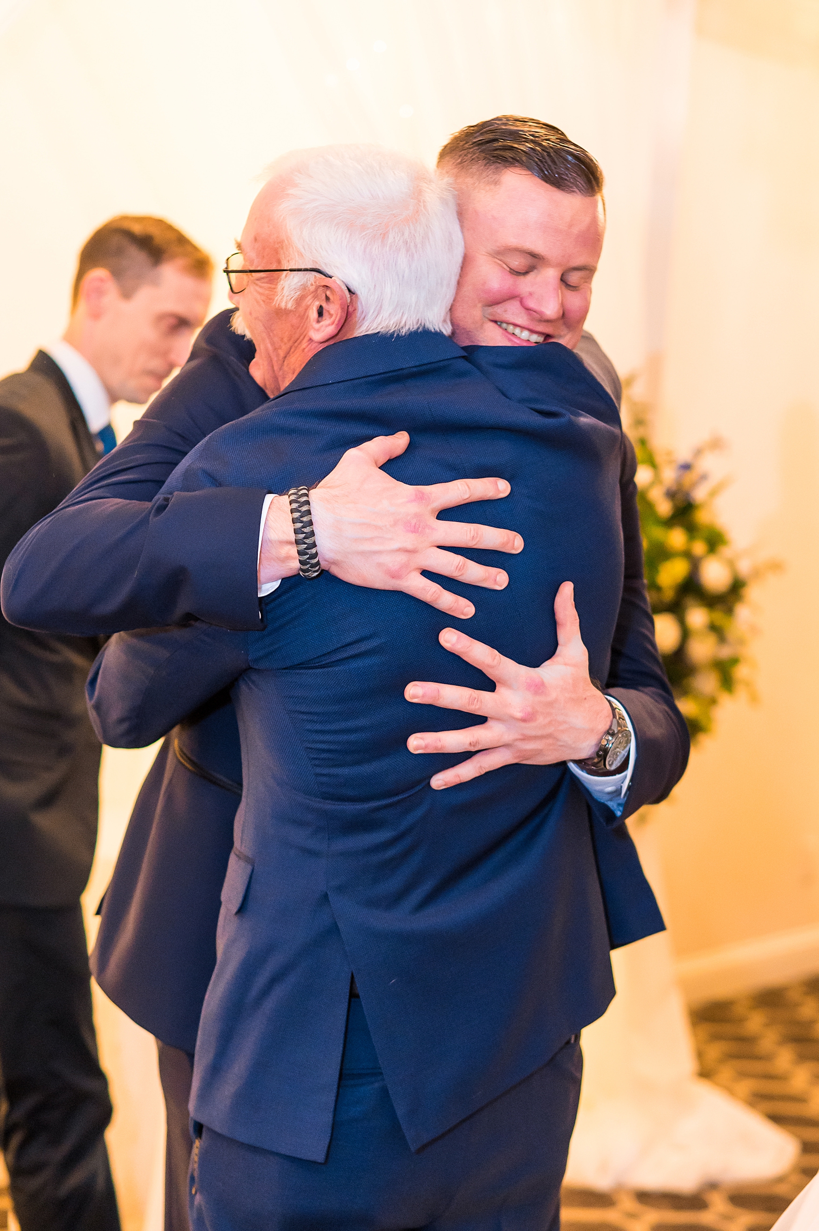 groom hugs father in law