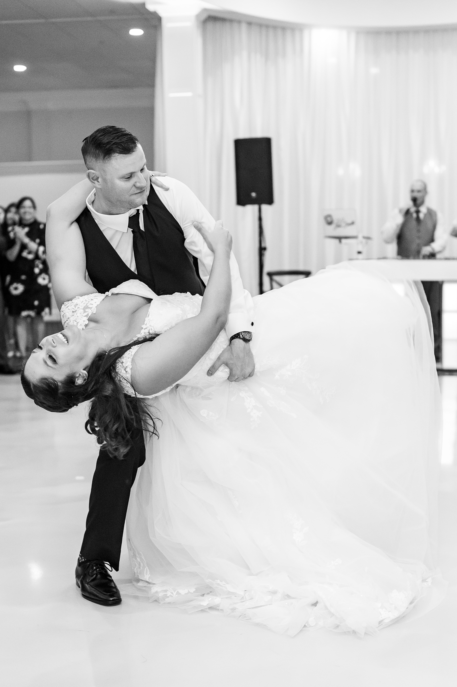 husband dips his new wife on the dance floor