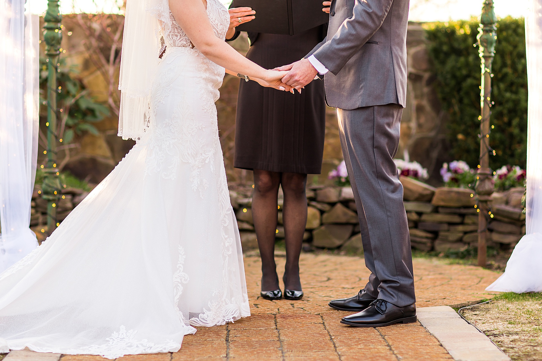 bride and groom hold hands at Wedgewood Granite Rose Wedding ceremony