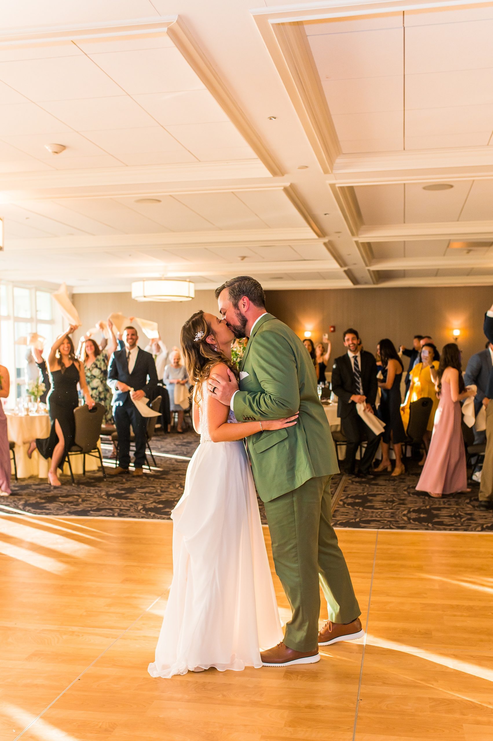 couple kiss on the dance floor at wedding reception