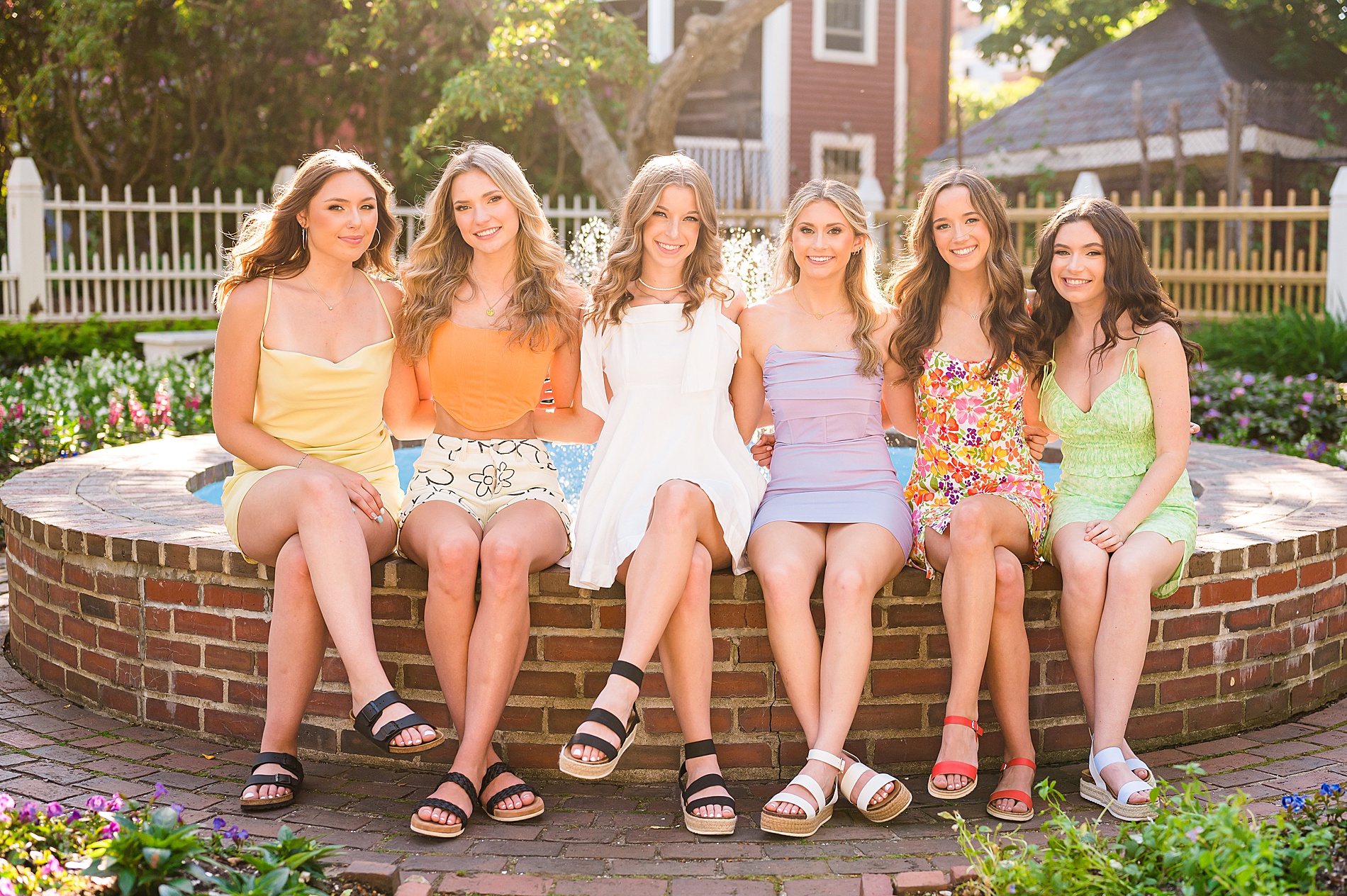 2023 Senior Spokesmodel Team sits around fountain during Styled Shoot in Portsmouth NH