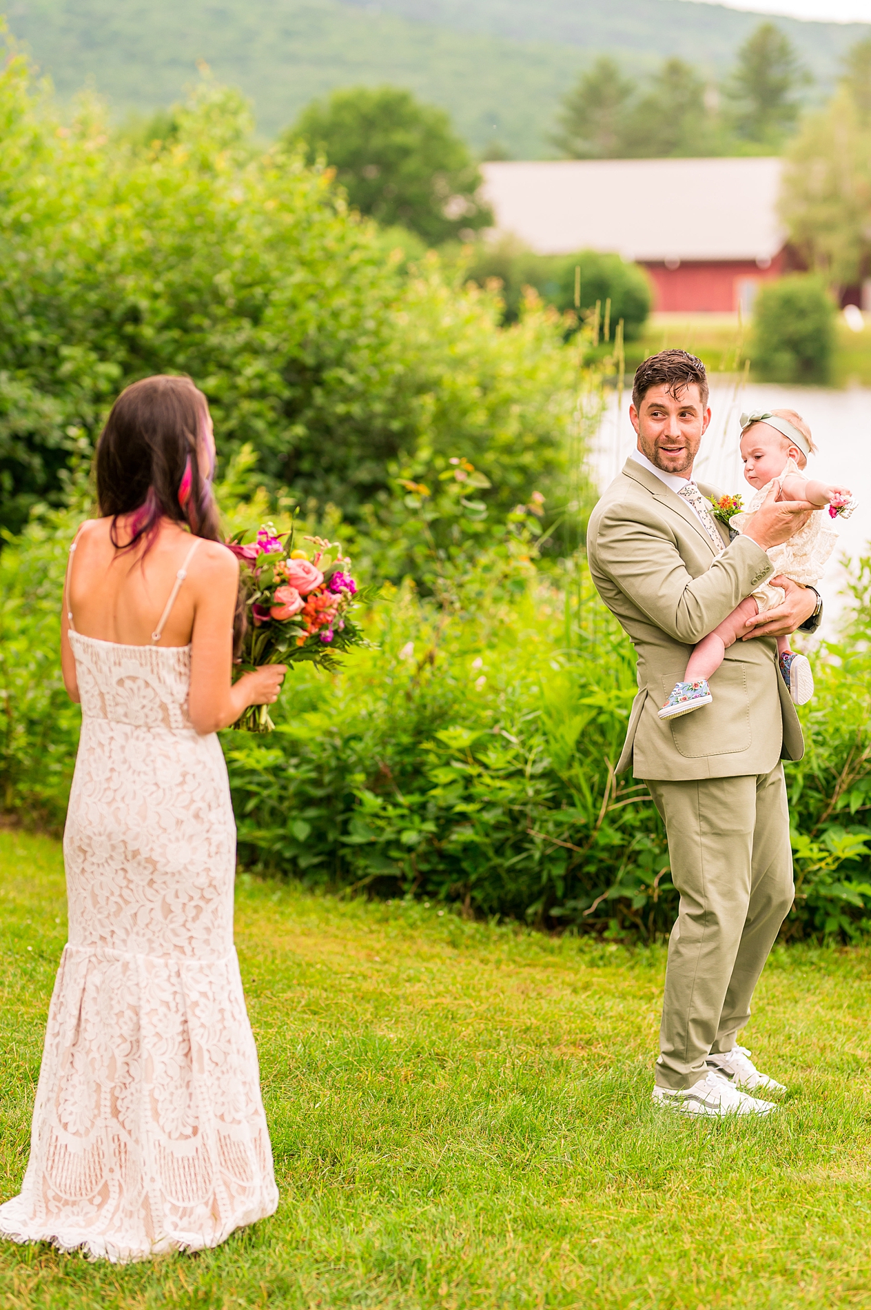 groom turns around to see his bride during first look on a hill overlooking the mountains 