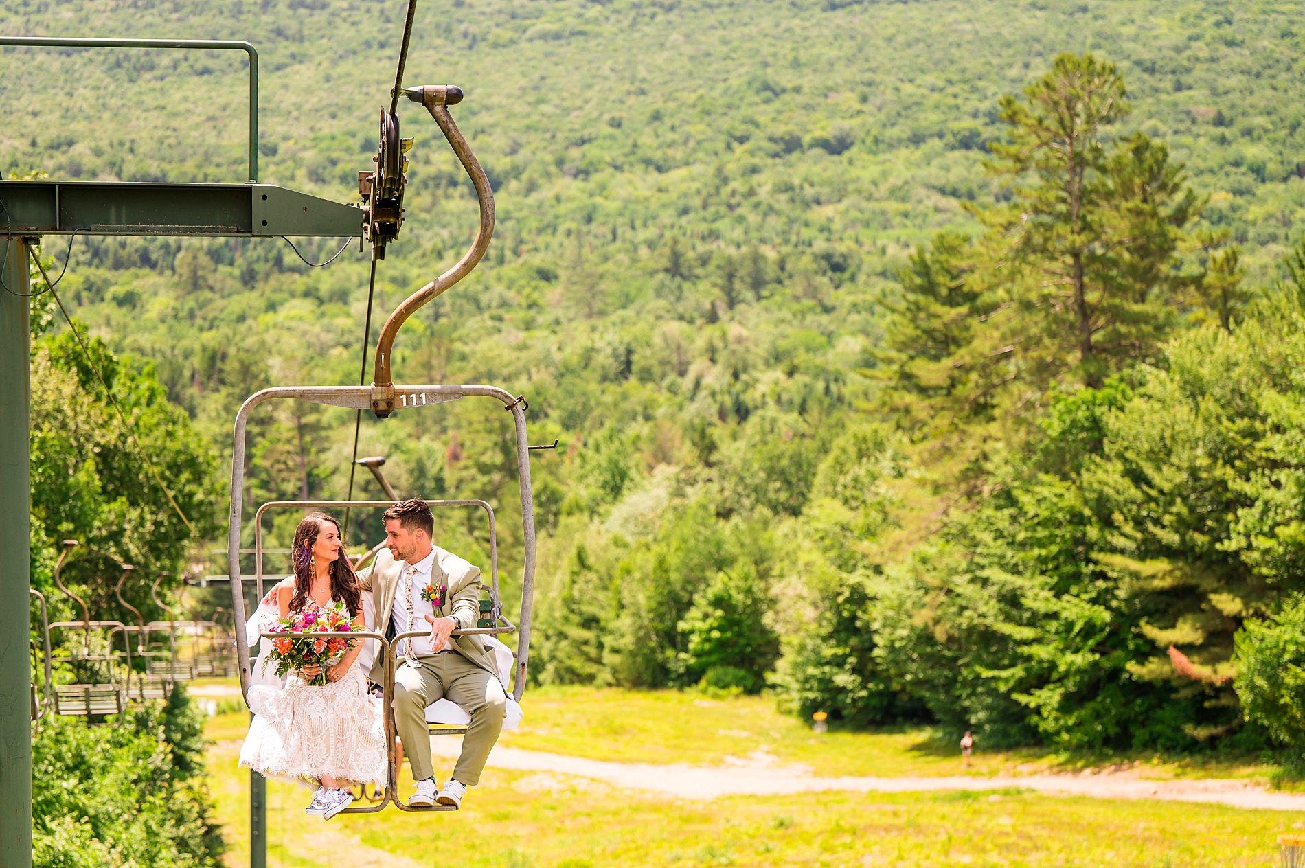 bride and groom ride the cable car up the mountain side 
