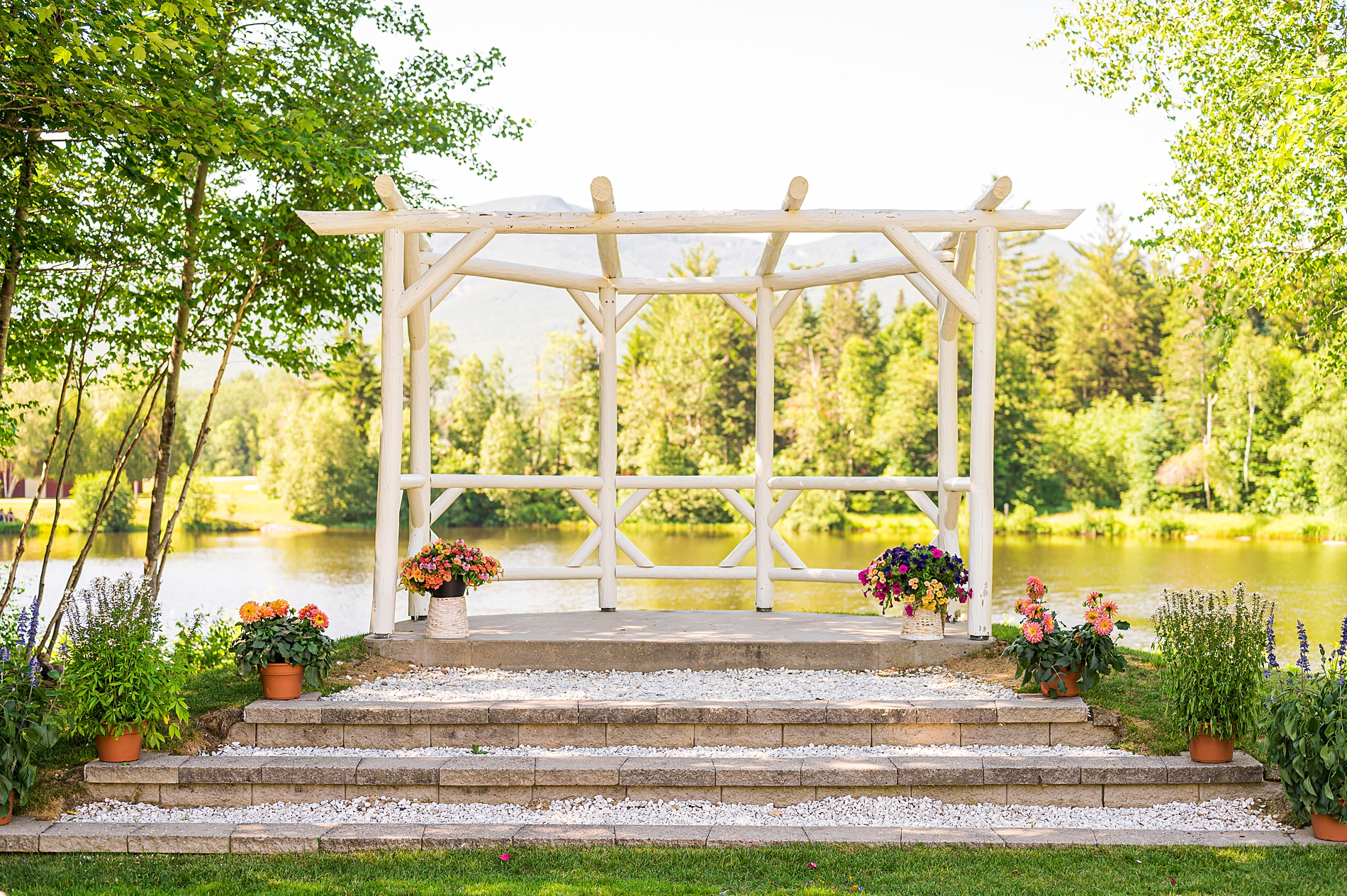 Outdoor NH Summer Wedding ceremony at Waterville Valley Resort overlooking the water and mountains