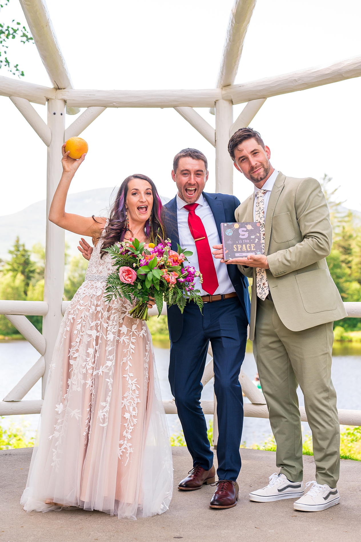Officiant and friend gives bride and groom special gifts after wedding