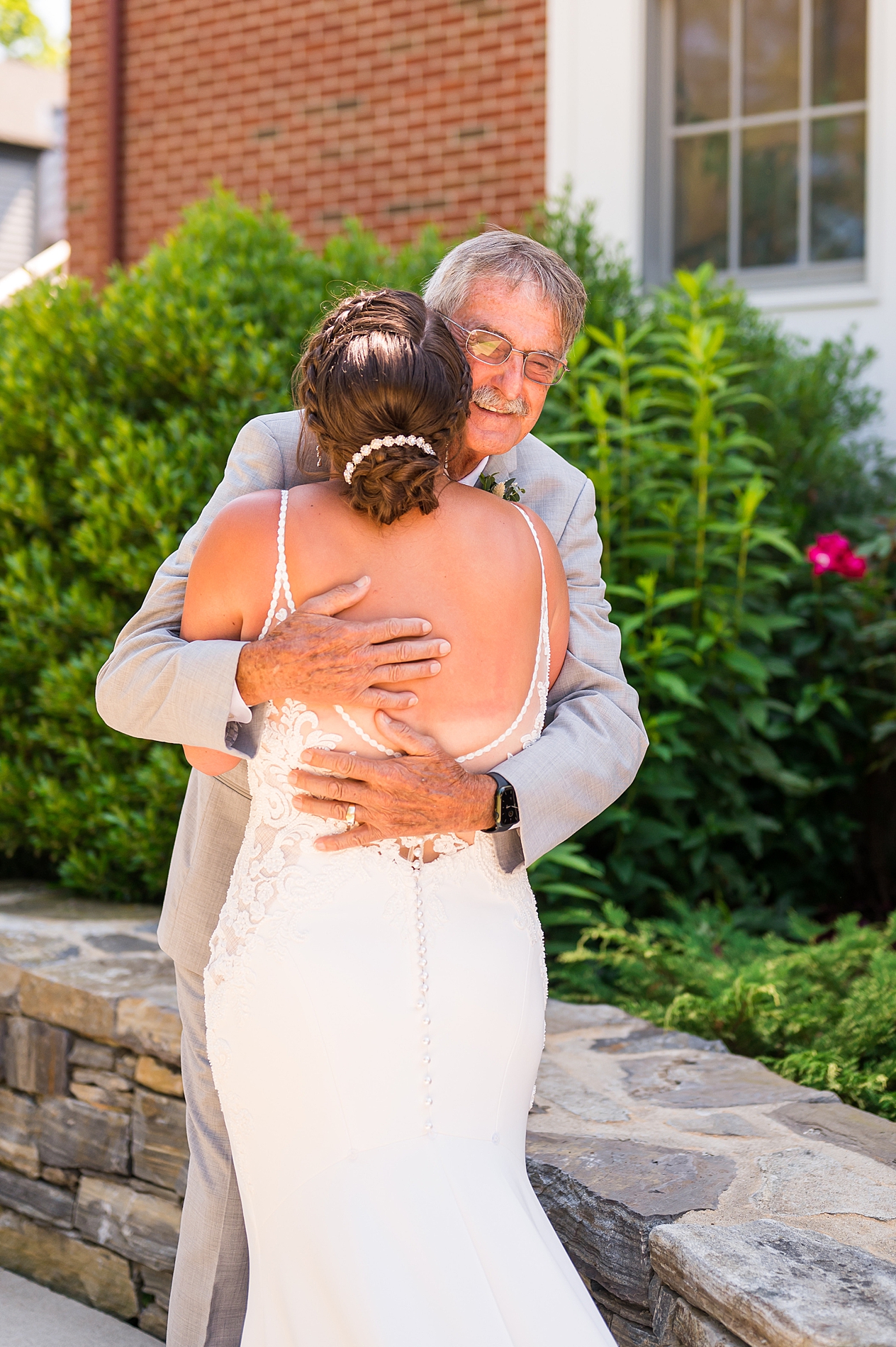 bride hugs her grandfather during first look