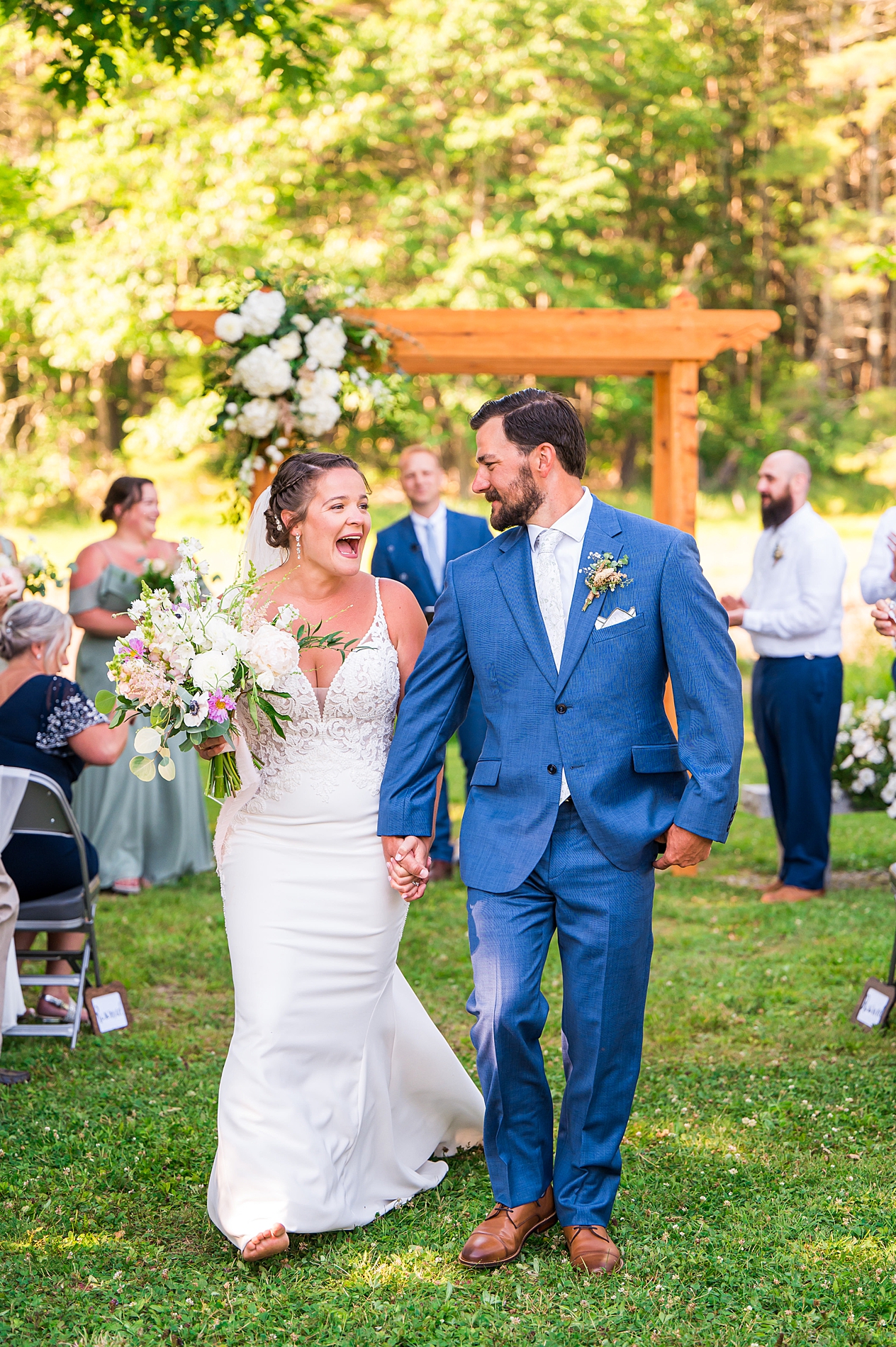 excited married couple walk down the aisle of wedding ceremony in Kennebunkport, ME