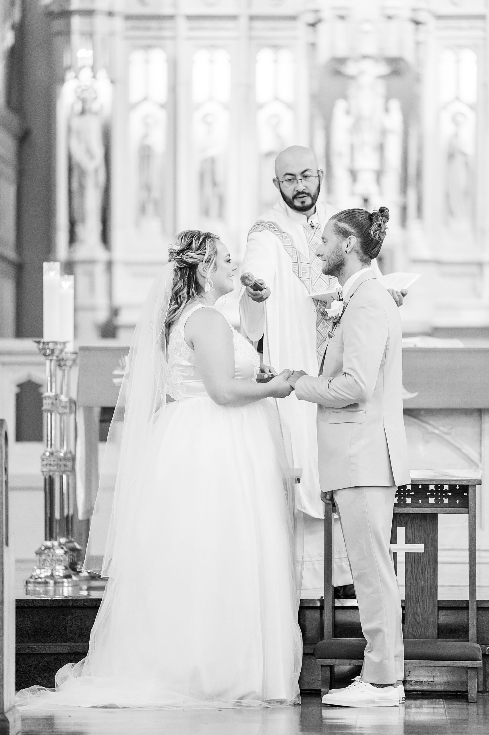 couple exchanging wedding vows at Catholic church in CT