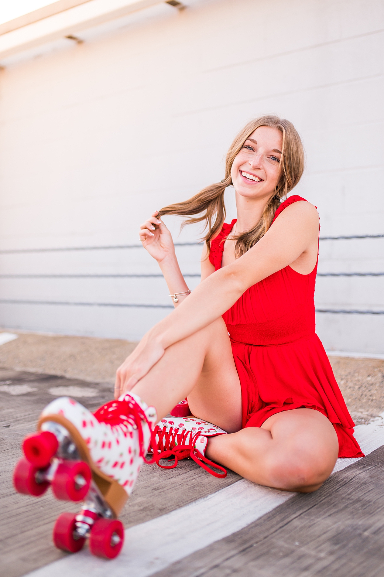 senior in red outfit and rollerskates 