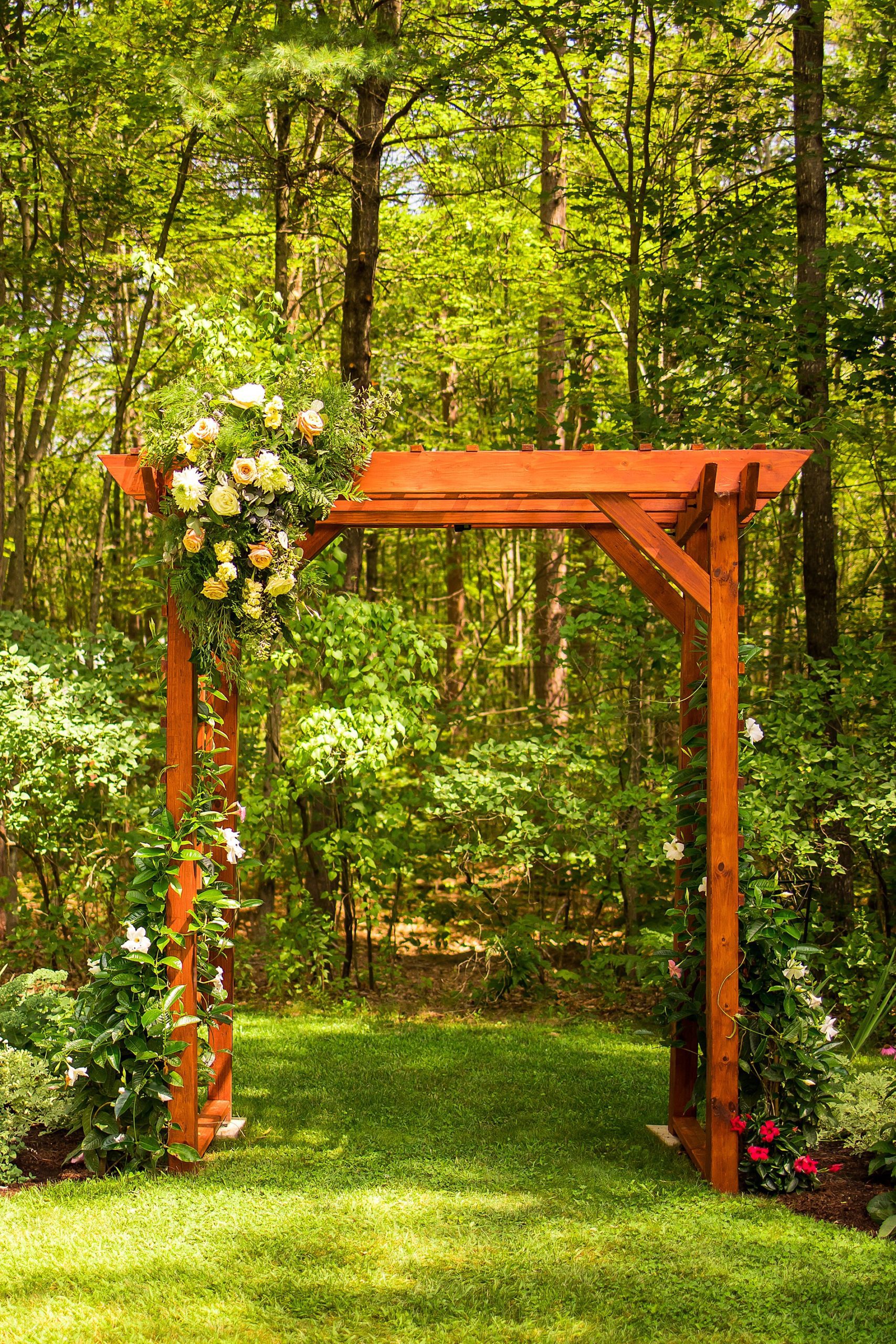 beautiful handmade wooden arbor decorated with florals for wedding ceremony 