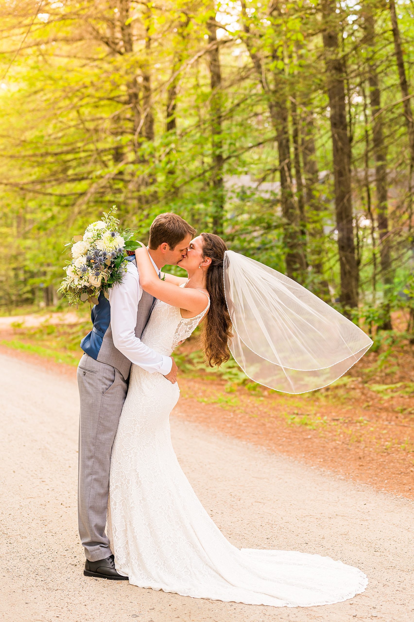 wedding portraits on gravel path in wooded area of Conway NH