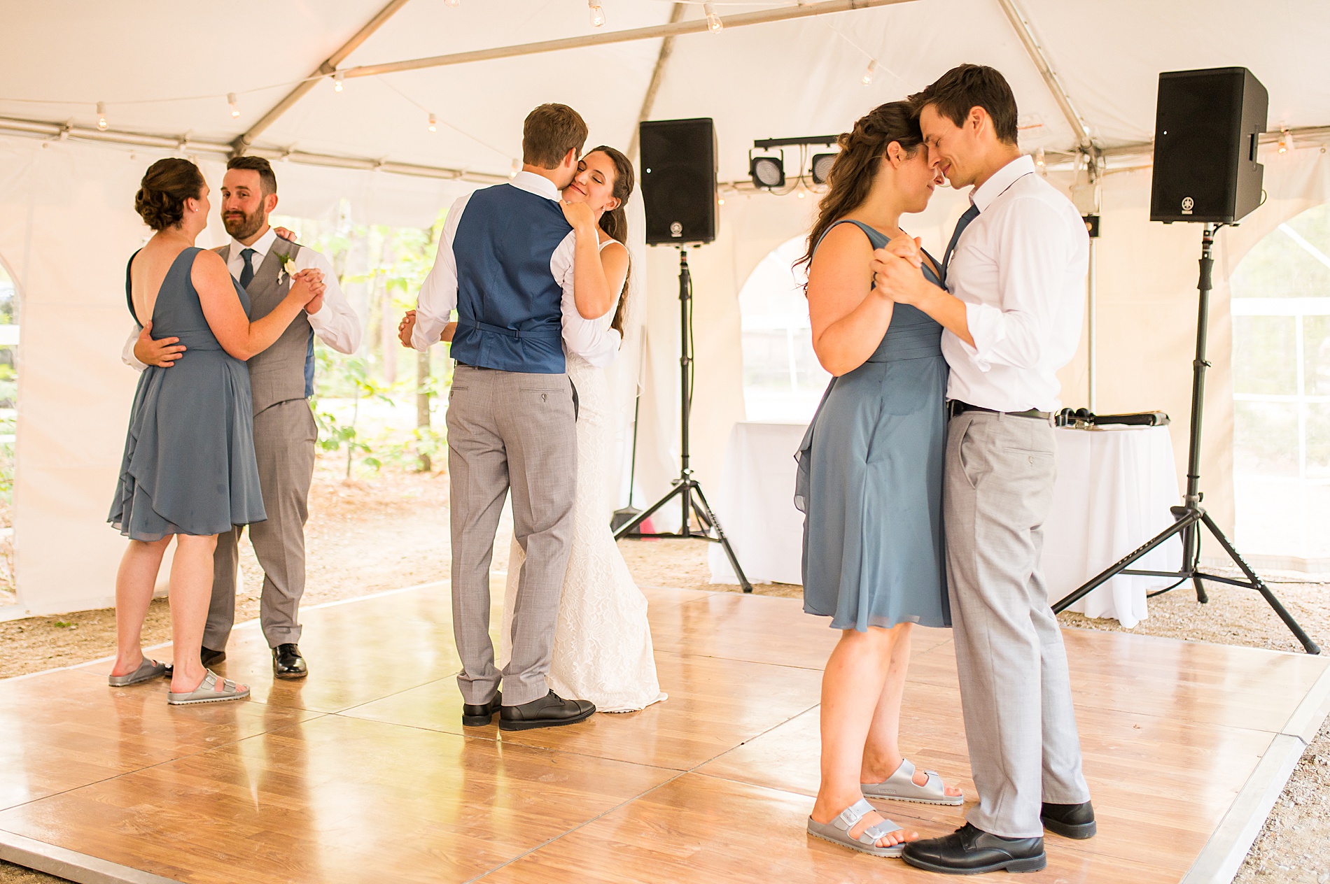 bride and groom share first dance with siblings at intimate summer wedding 