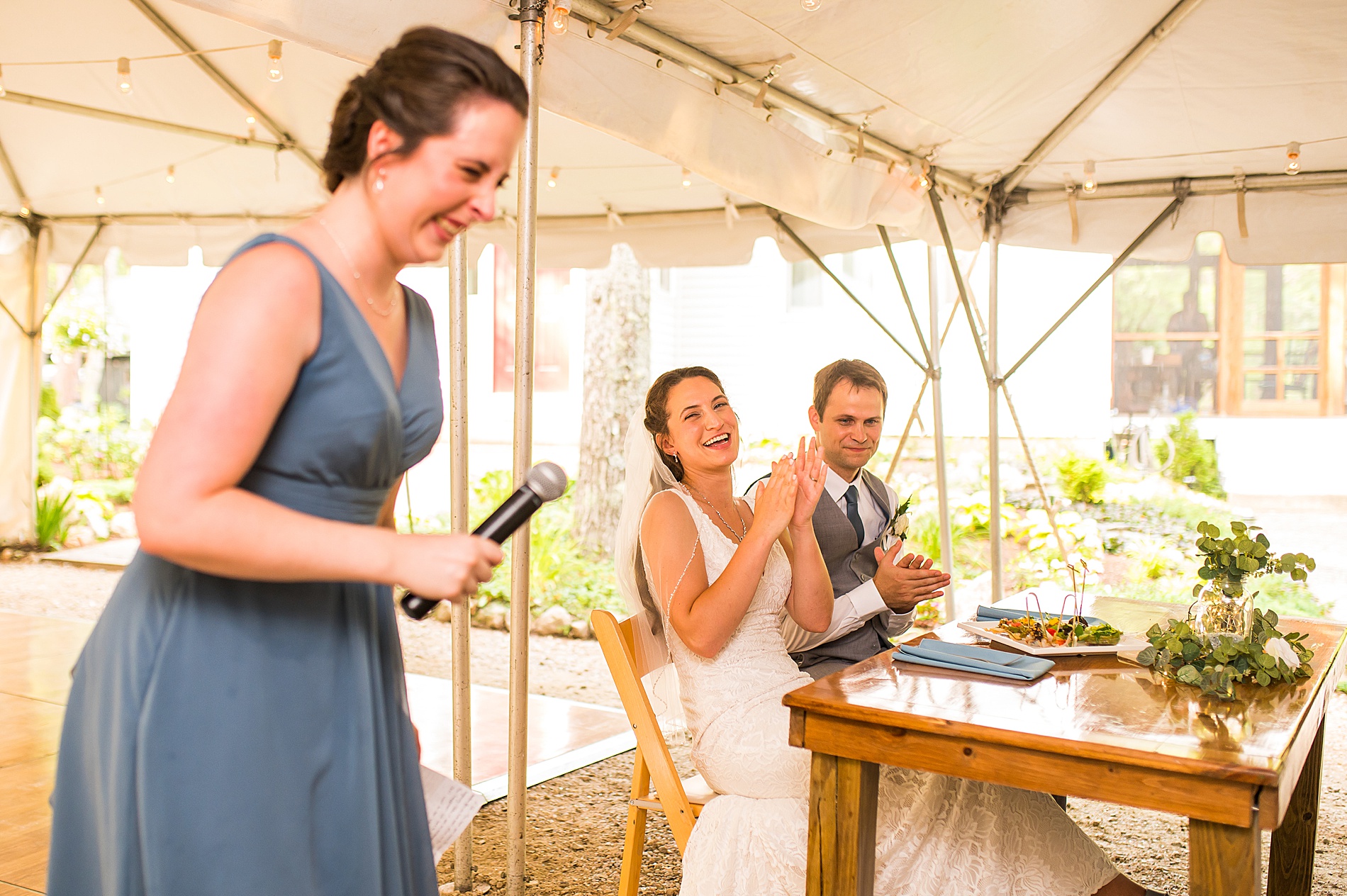 bride and groom laugh during wedding toasts at intimate summer wedding 