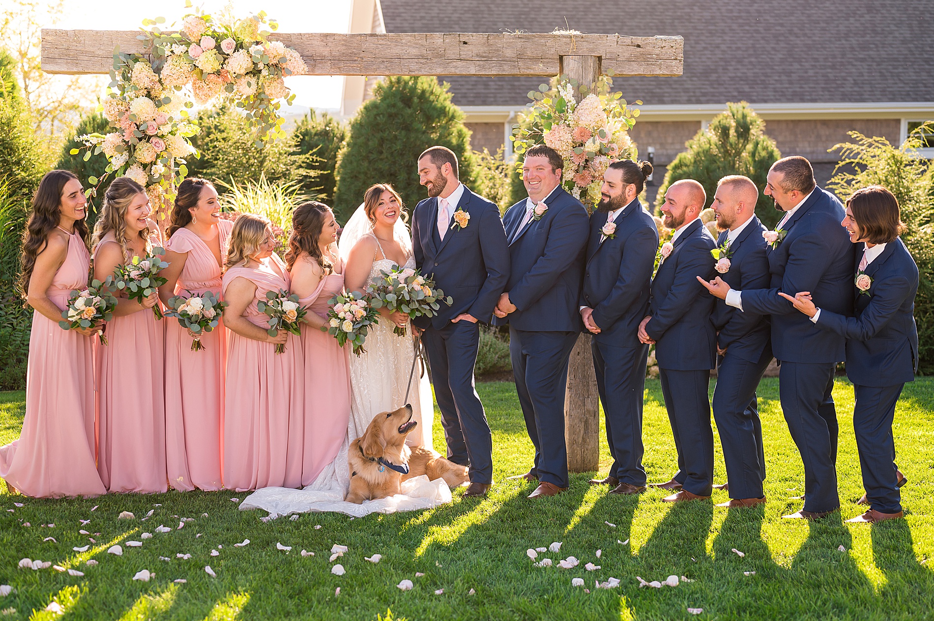 bridal party surround bride and groom for wedding portraits 