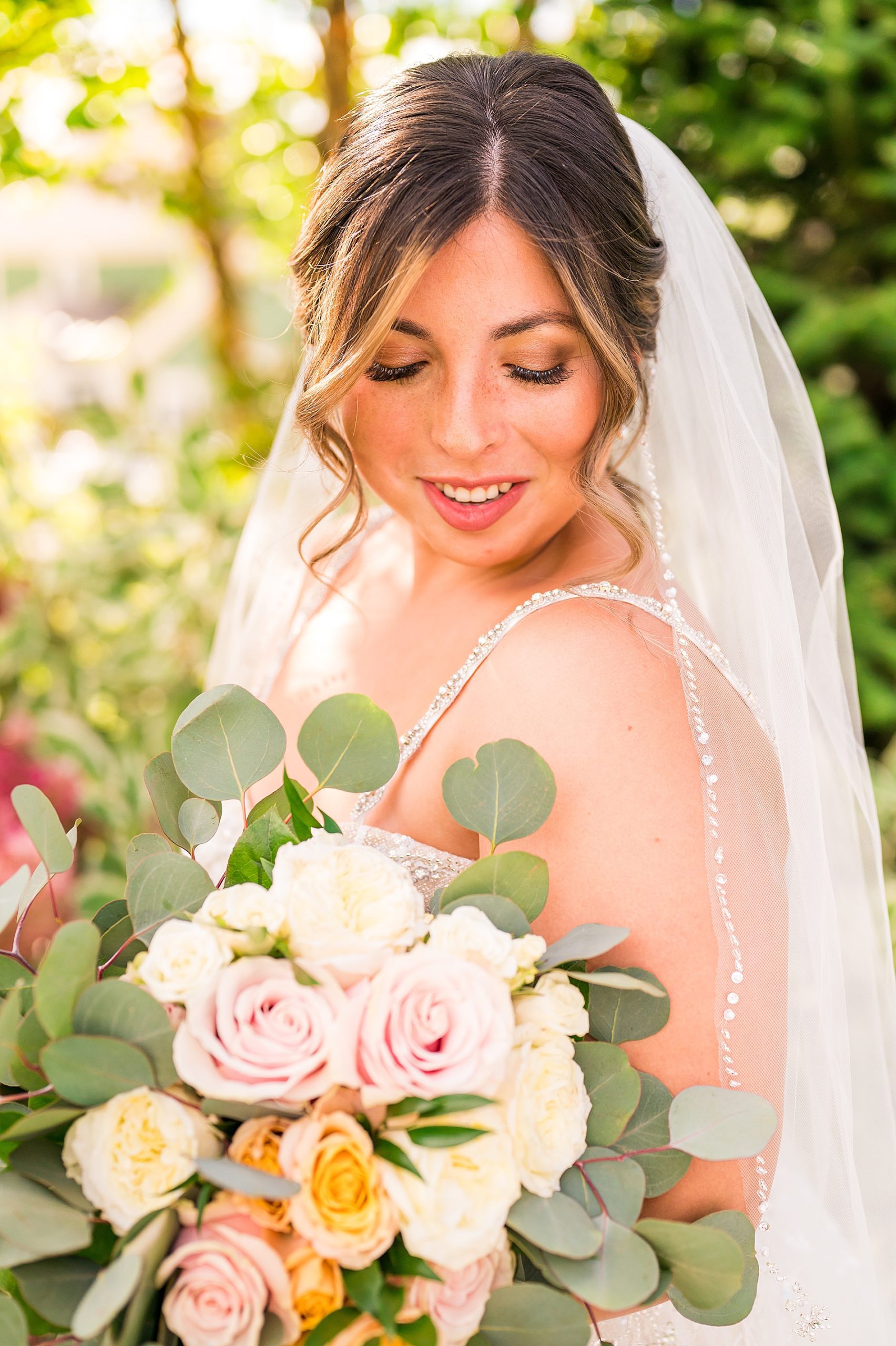 bride holding summer wedding flower bouquet 