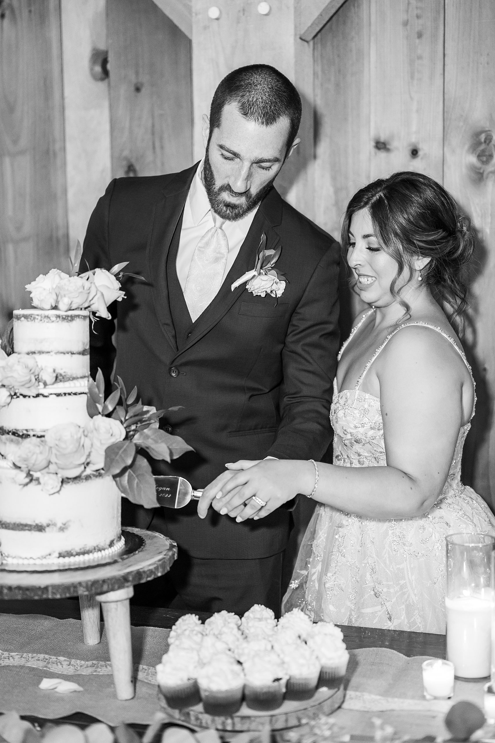 bride and groom curt their wedding cake