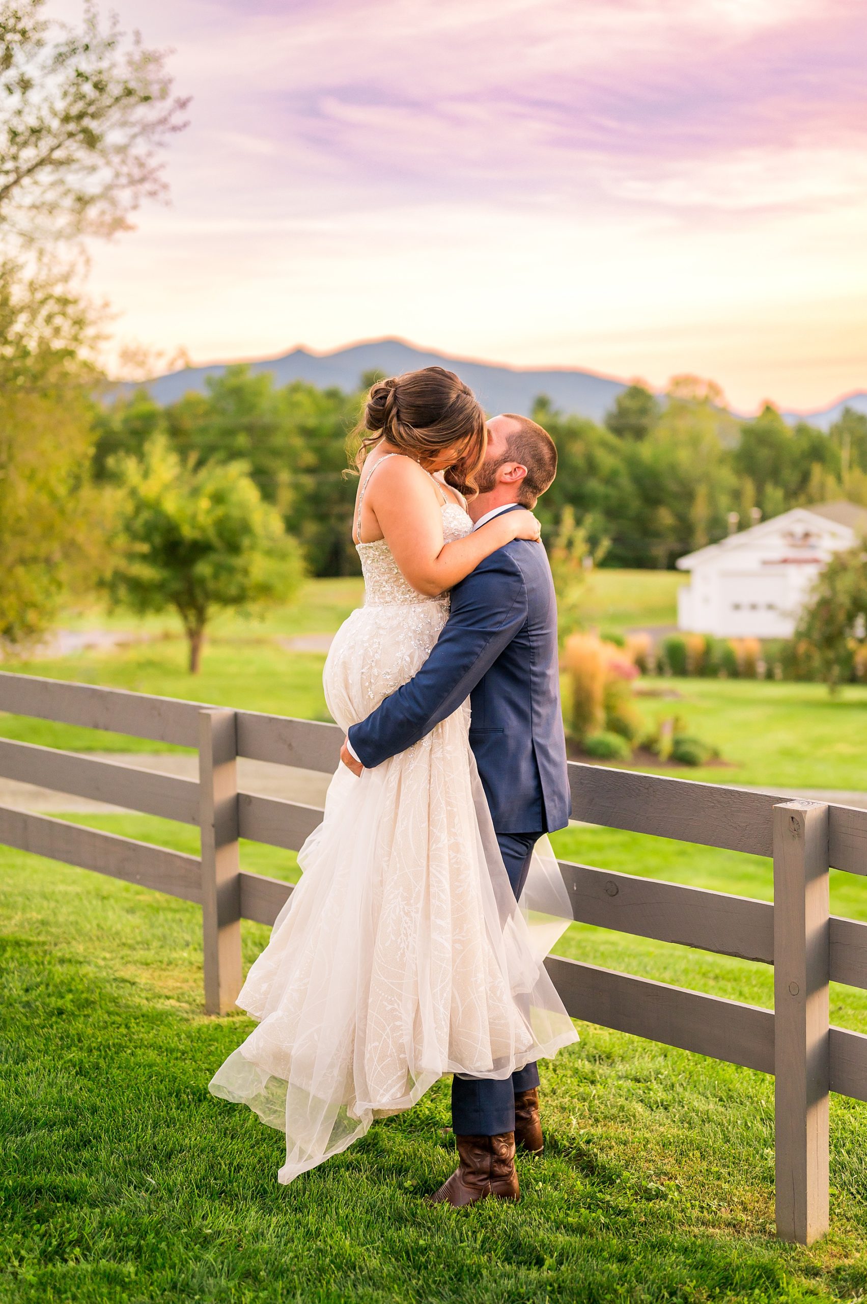 groom kisses his bride at sunset 