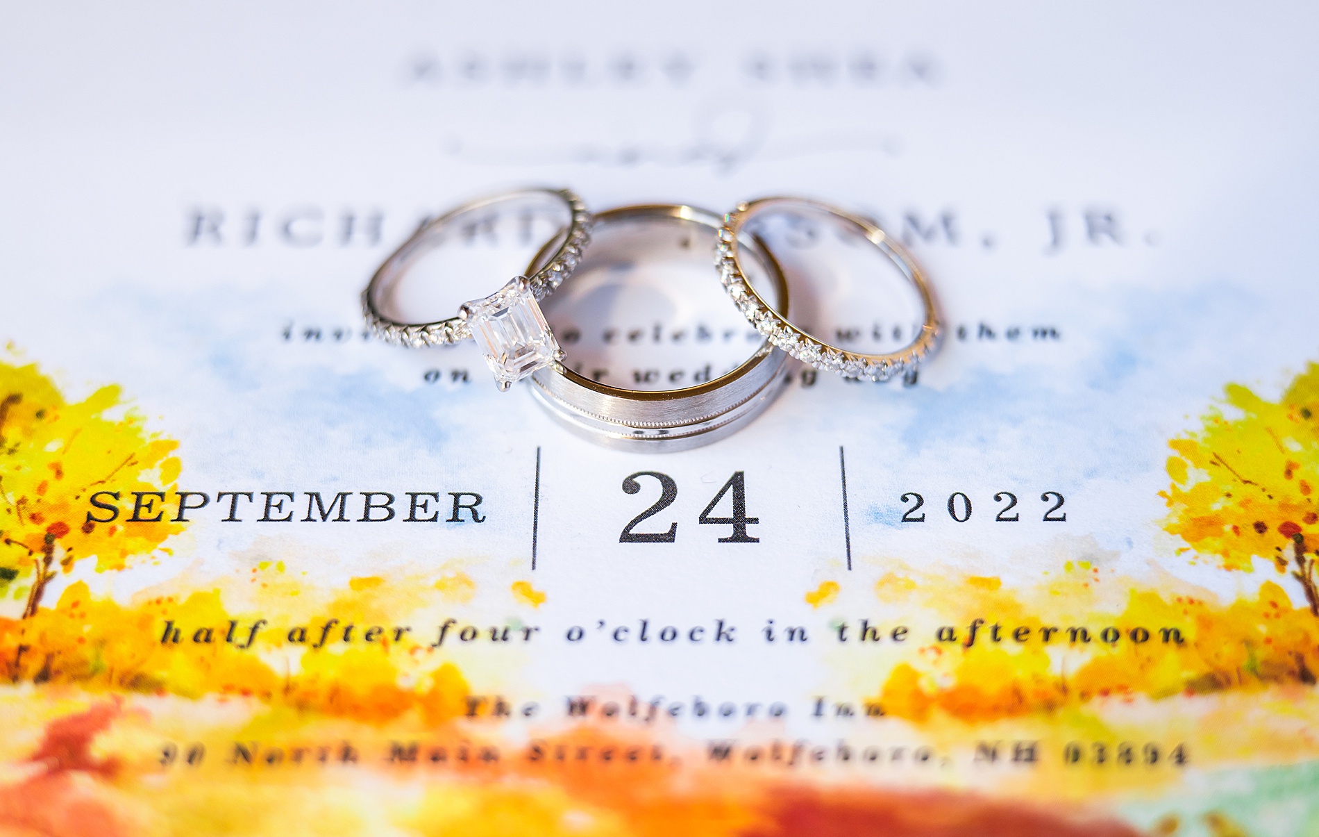 wedding rings on fall themed wedding invite