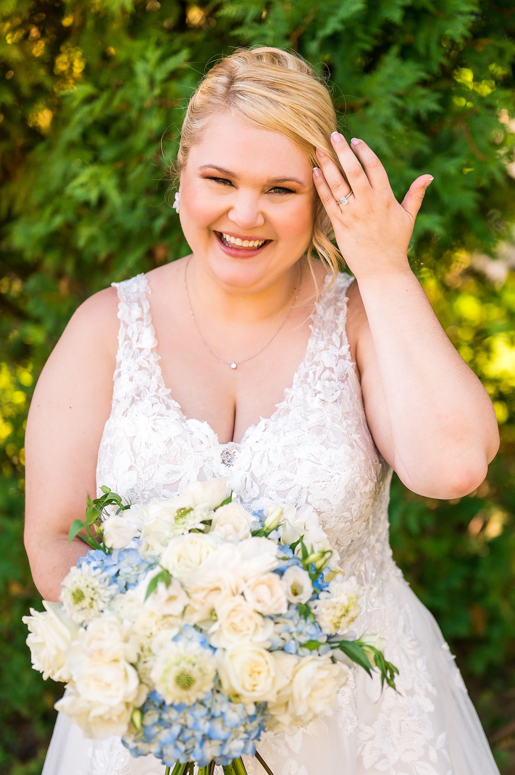 bride portraits holding blue and white wedding bouquet