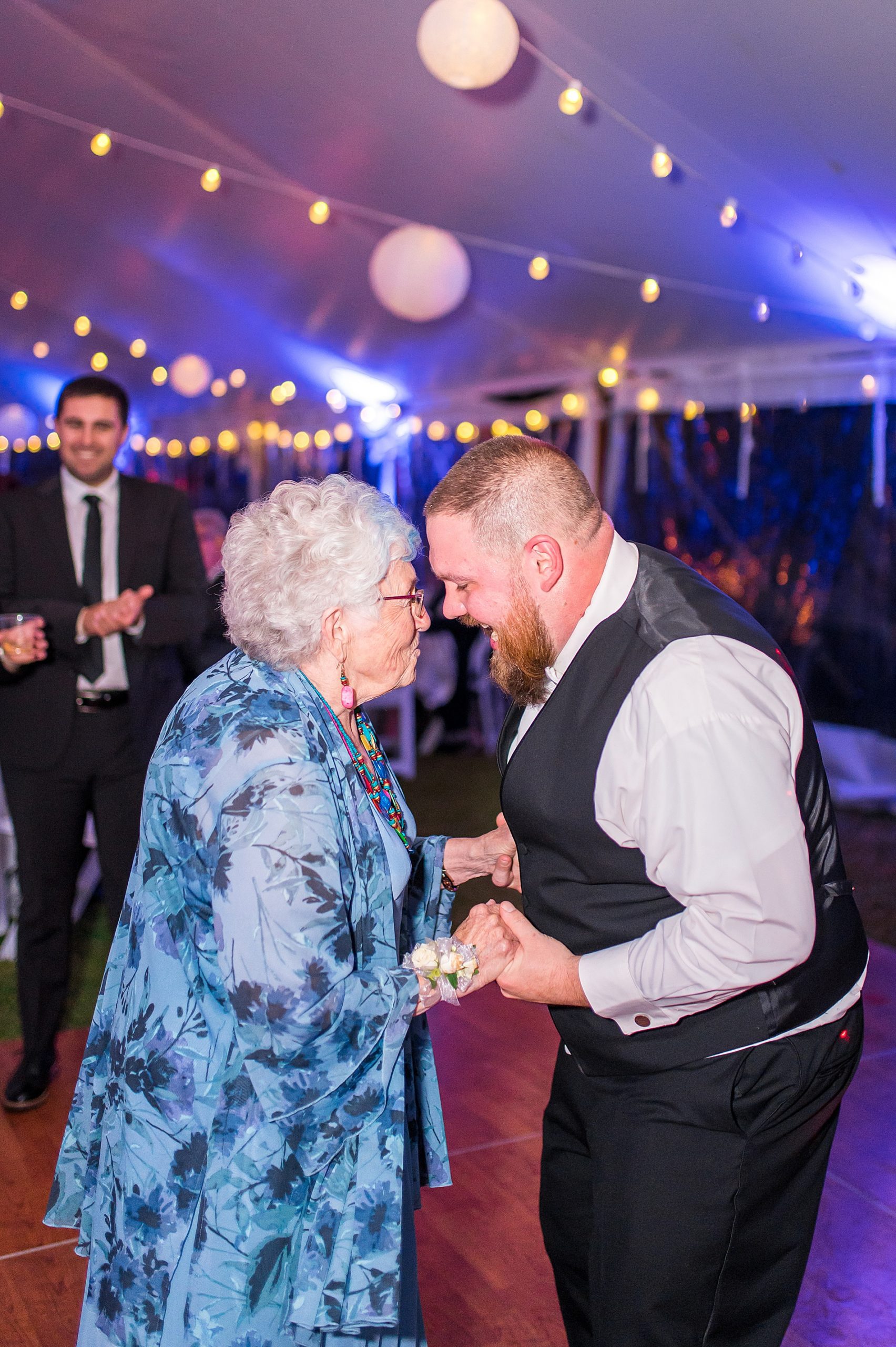 groom dances with his grandmother at wedding reception