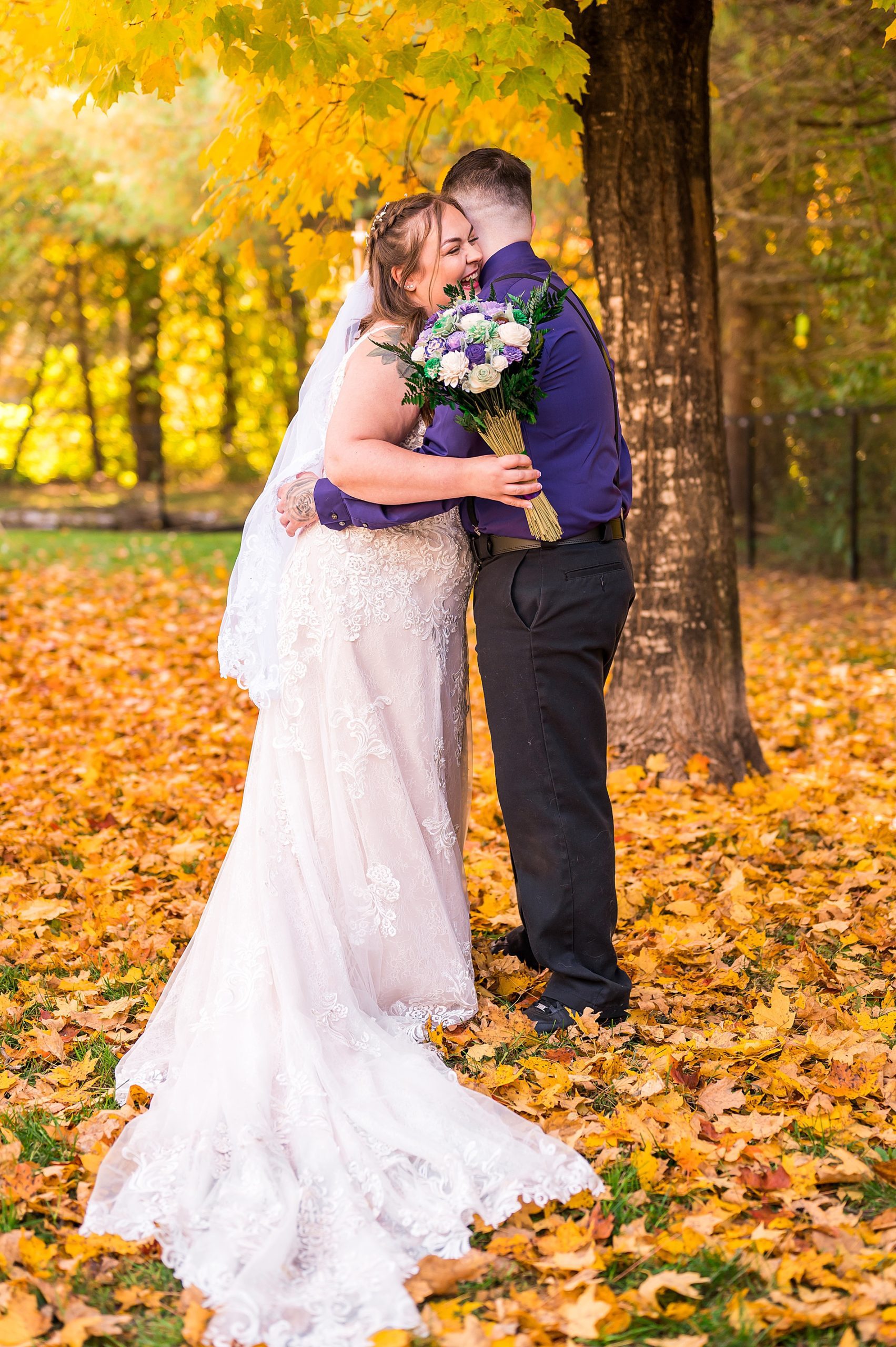 couple hug during first look in the woods