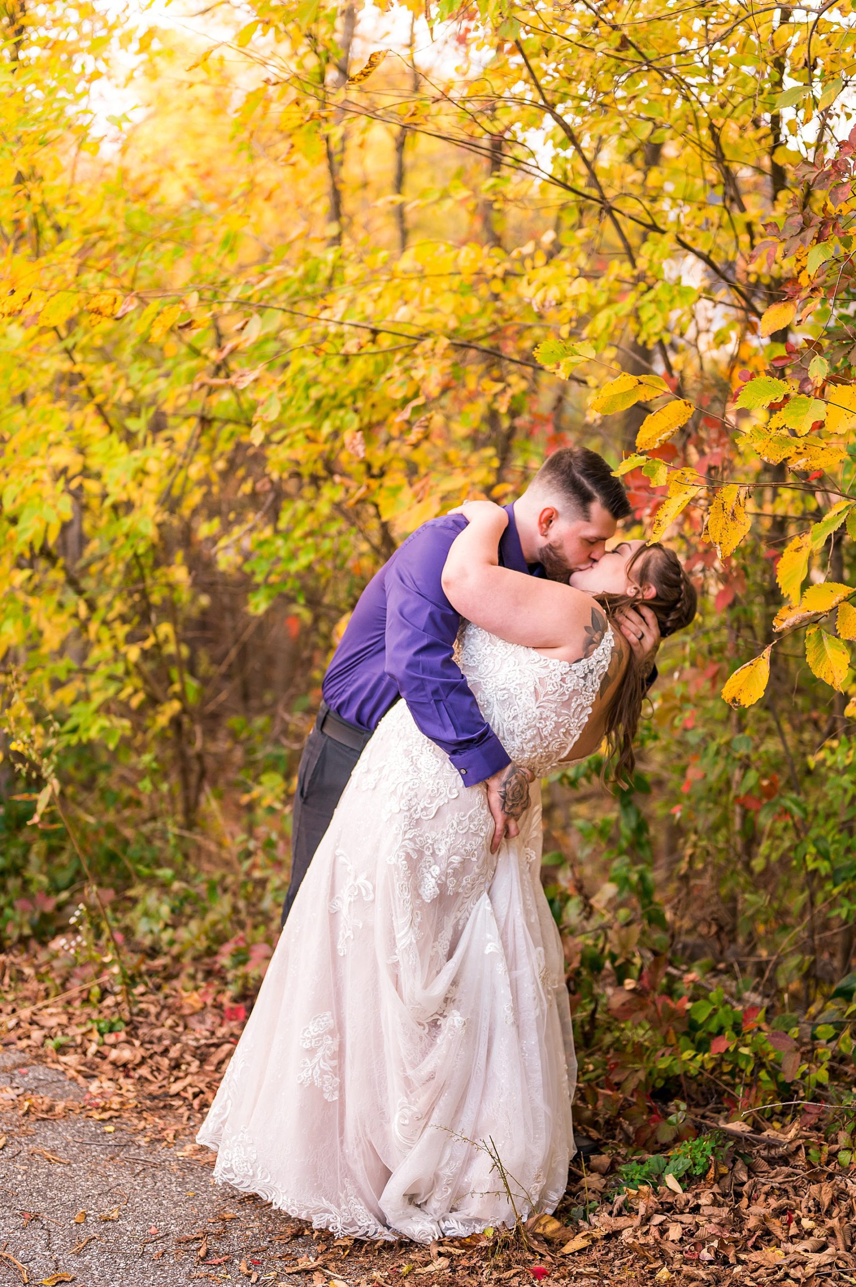 newlyweds kiss after Intimate Backyard Fall Wedding