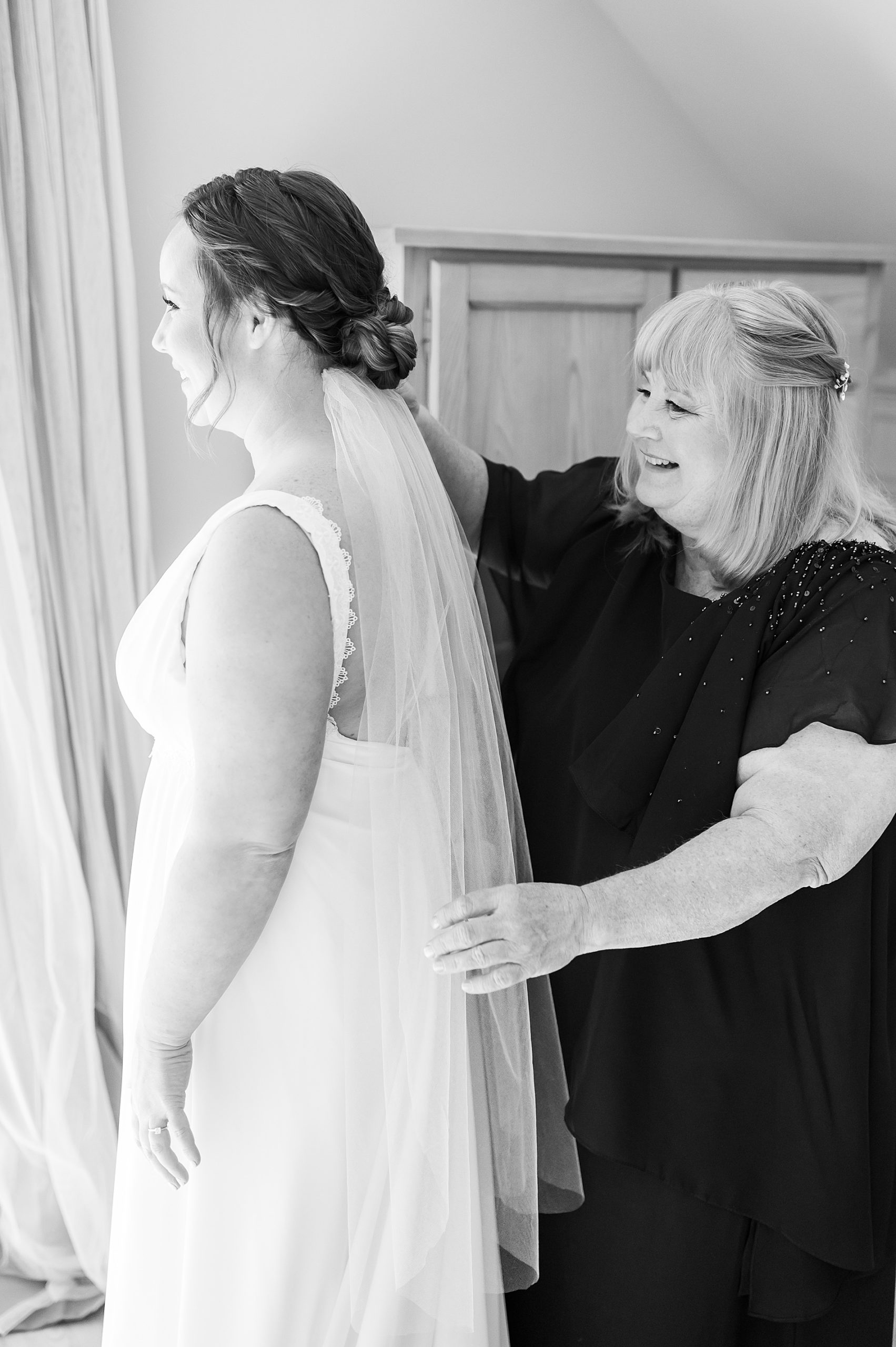 mom helping bride with veil 