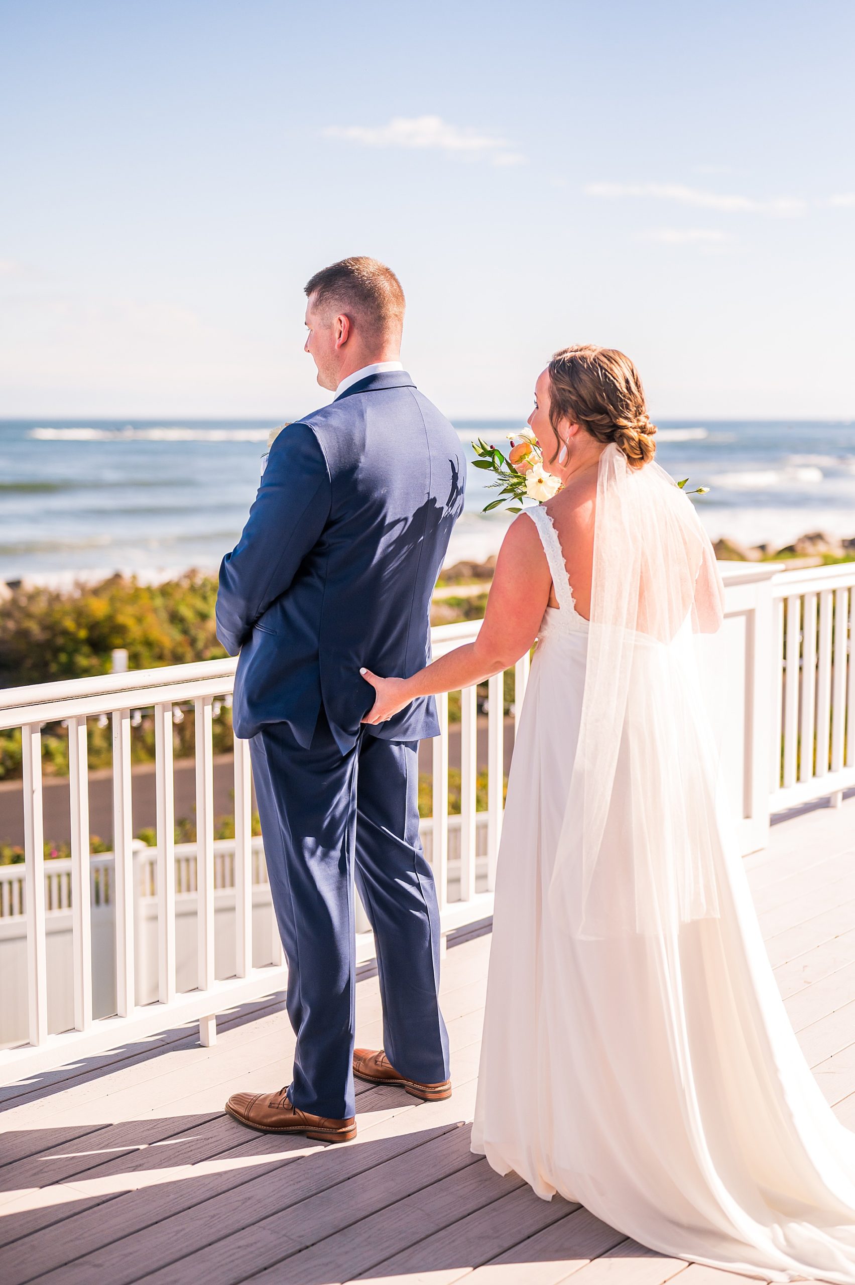 bride sneaks up on groom during first look on balcony 