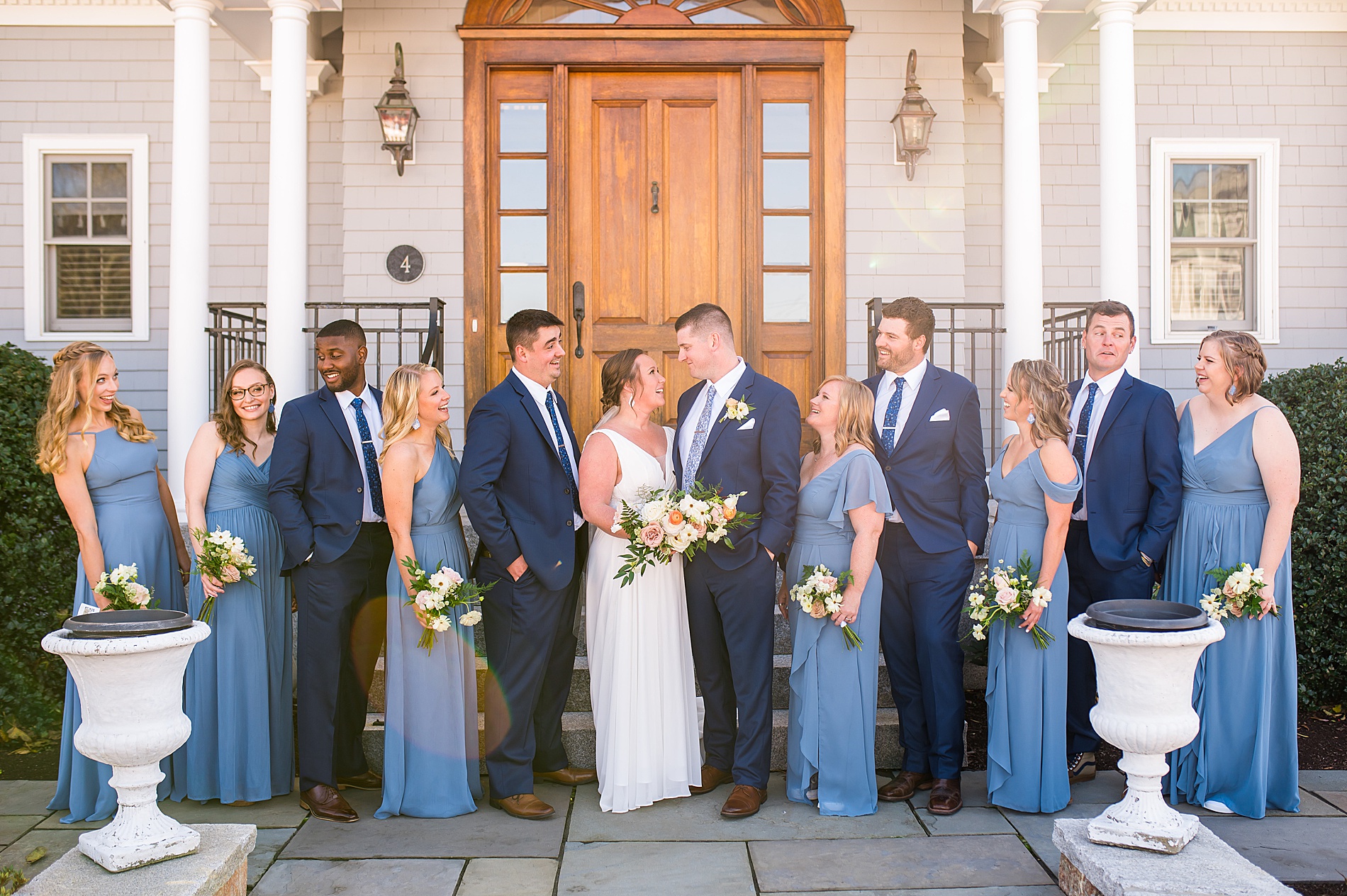 bridal party surrounds bride and groom