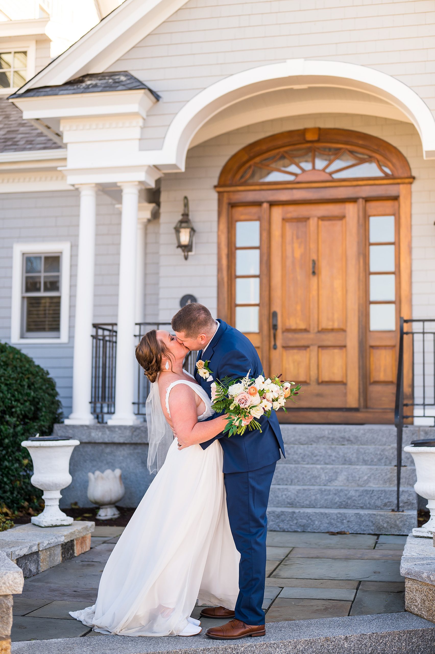 couple kiss in front of private residence in NH