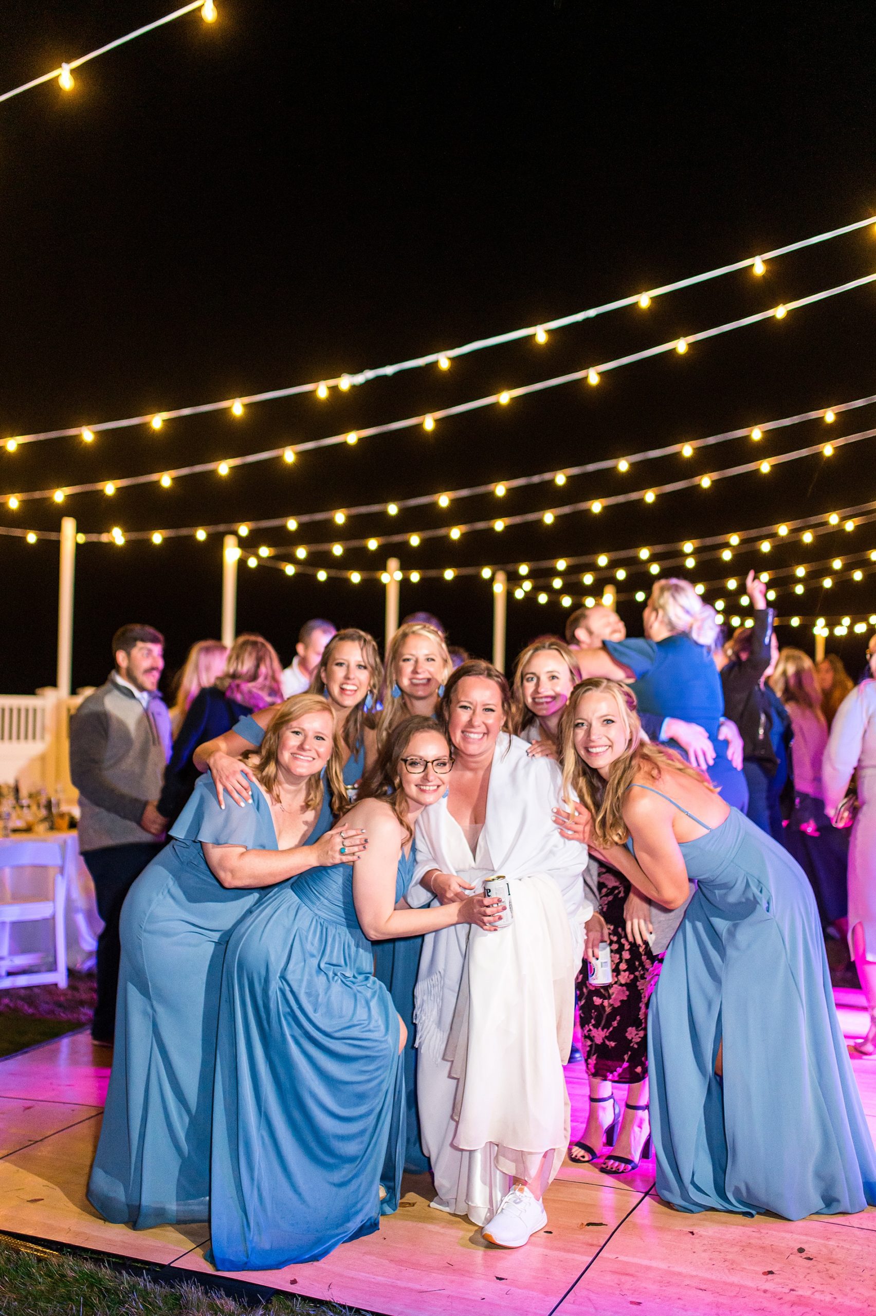 bride on the dance floor with her bridesmaids at Oceanfront Autumn Wedding reception