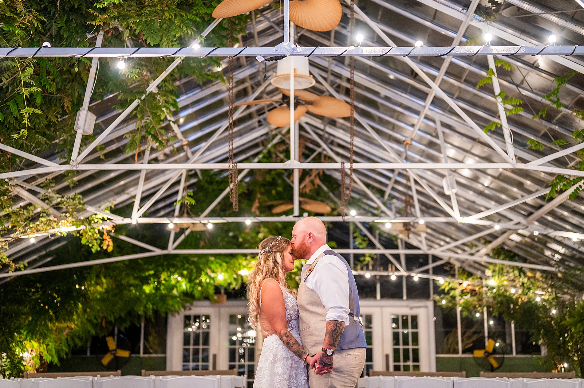 groom kisses his bride on the forehead during wedding portraits 