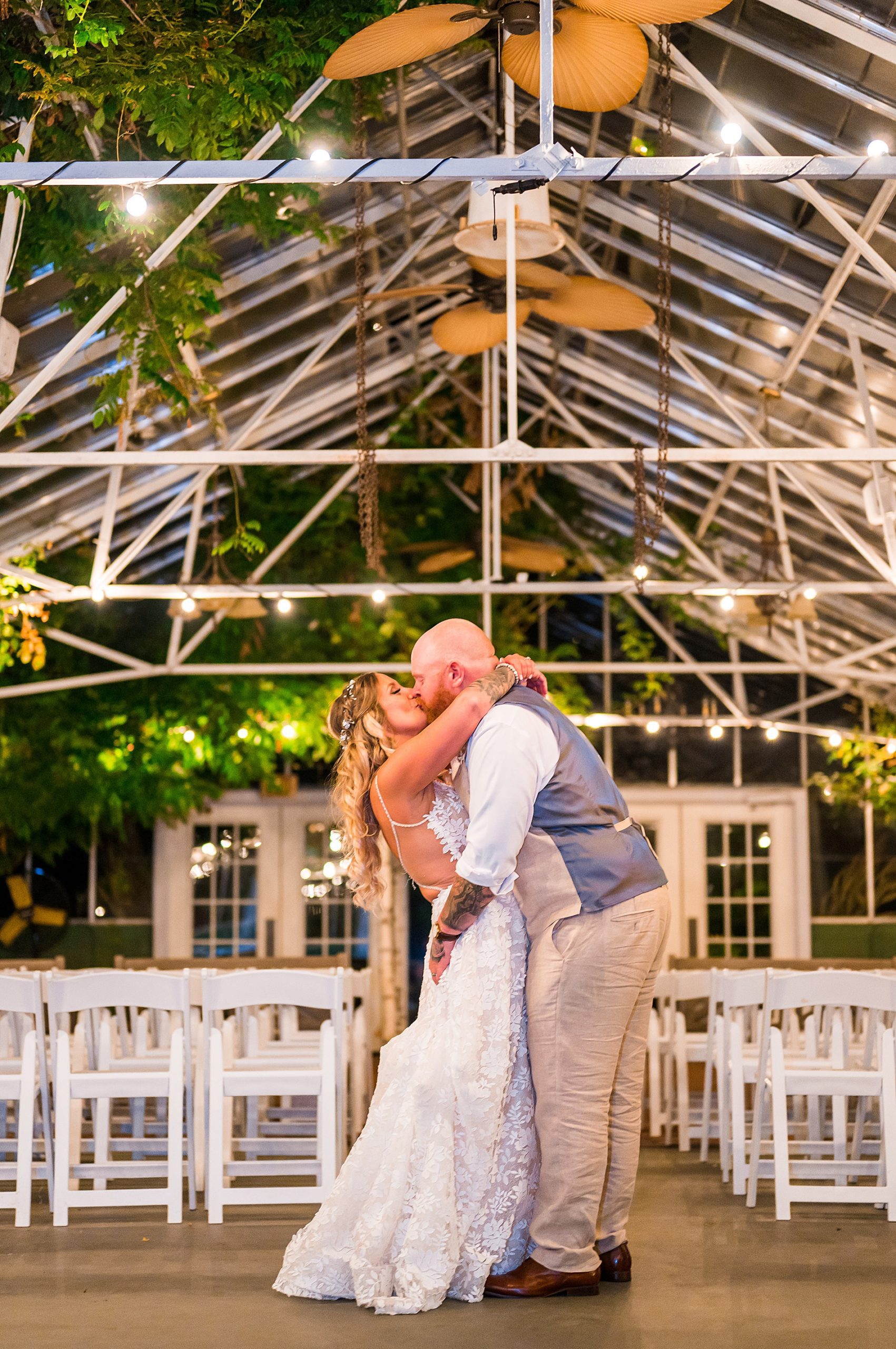wedding portraits inside lit up greenhouse at Barn on the Pemi at night 