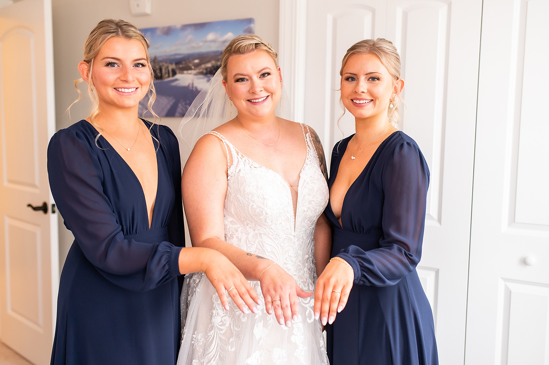 bride and sisters show off matching rings