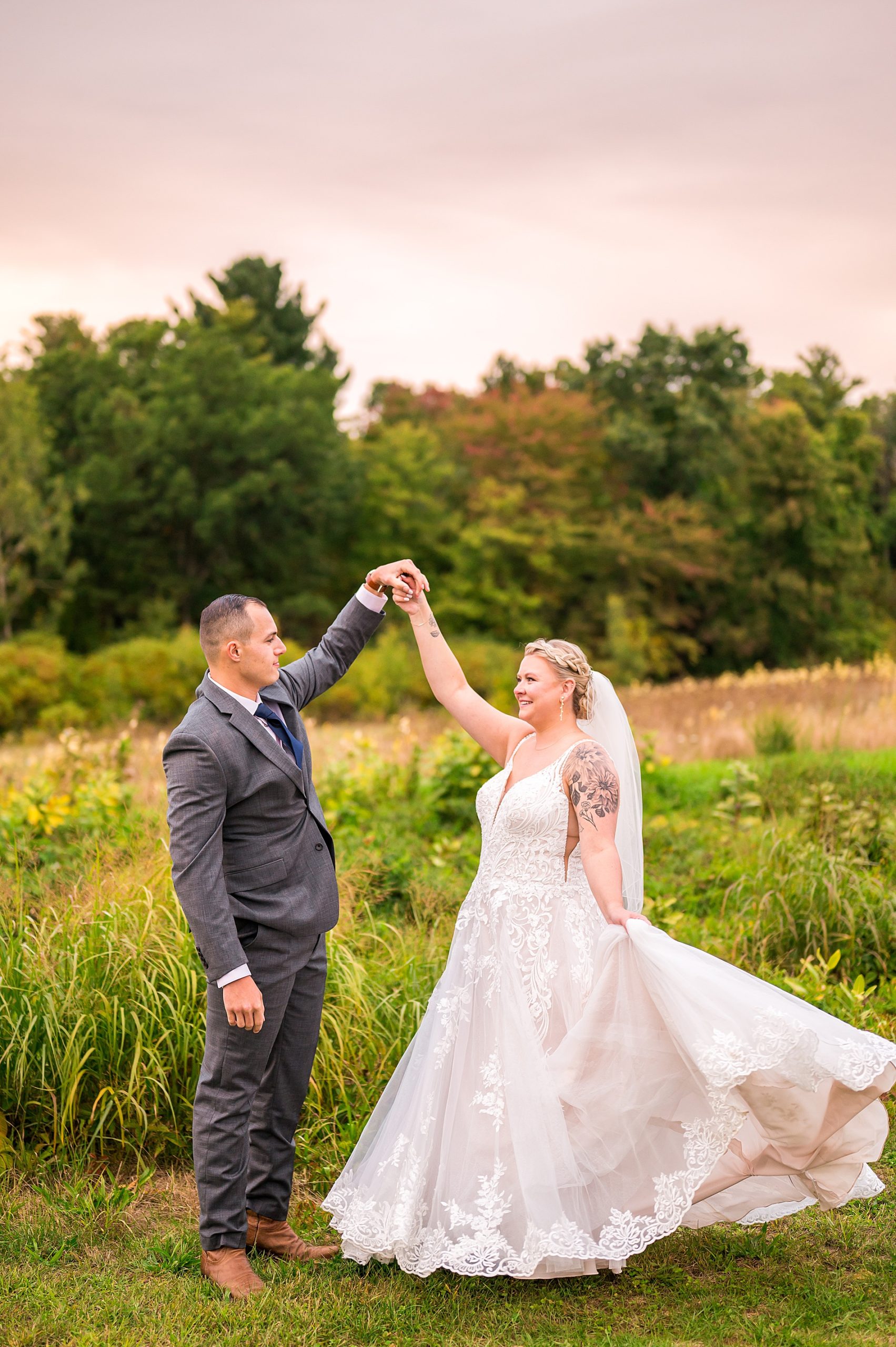 bride and groom dance outside during sunset wedding portraits 
