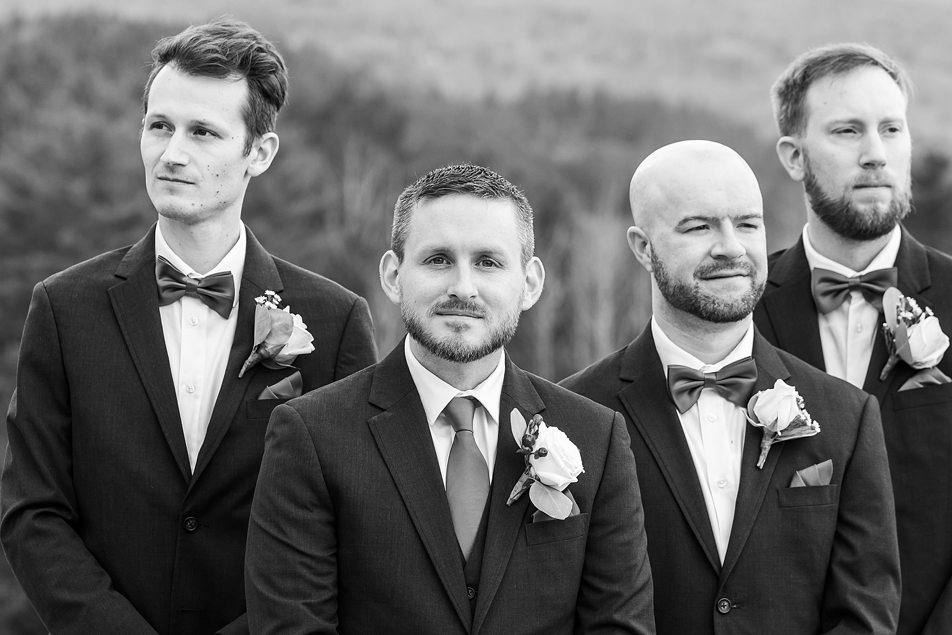 groom stands with groomsmen before Owl's Nest Resort Fall Wedding ceremony