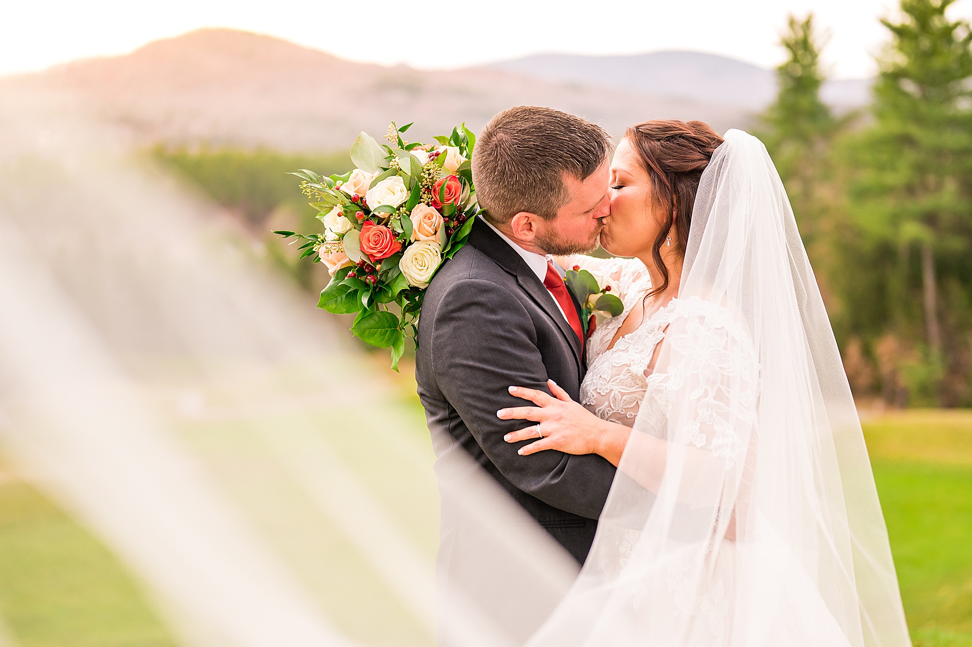 veil flutters around bride and groom 